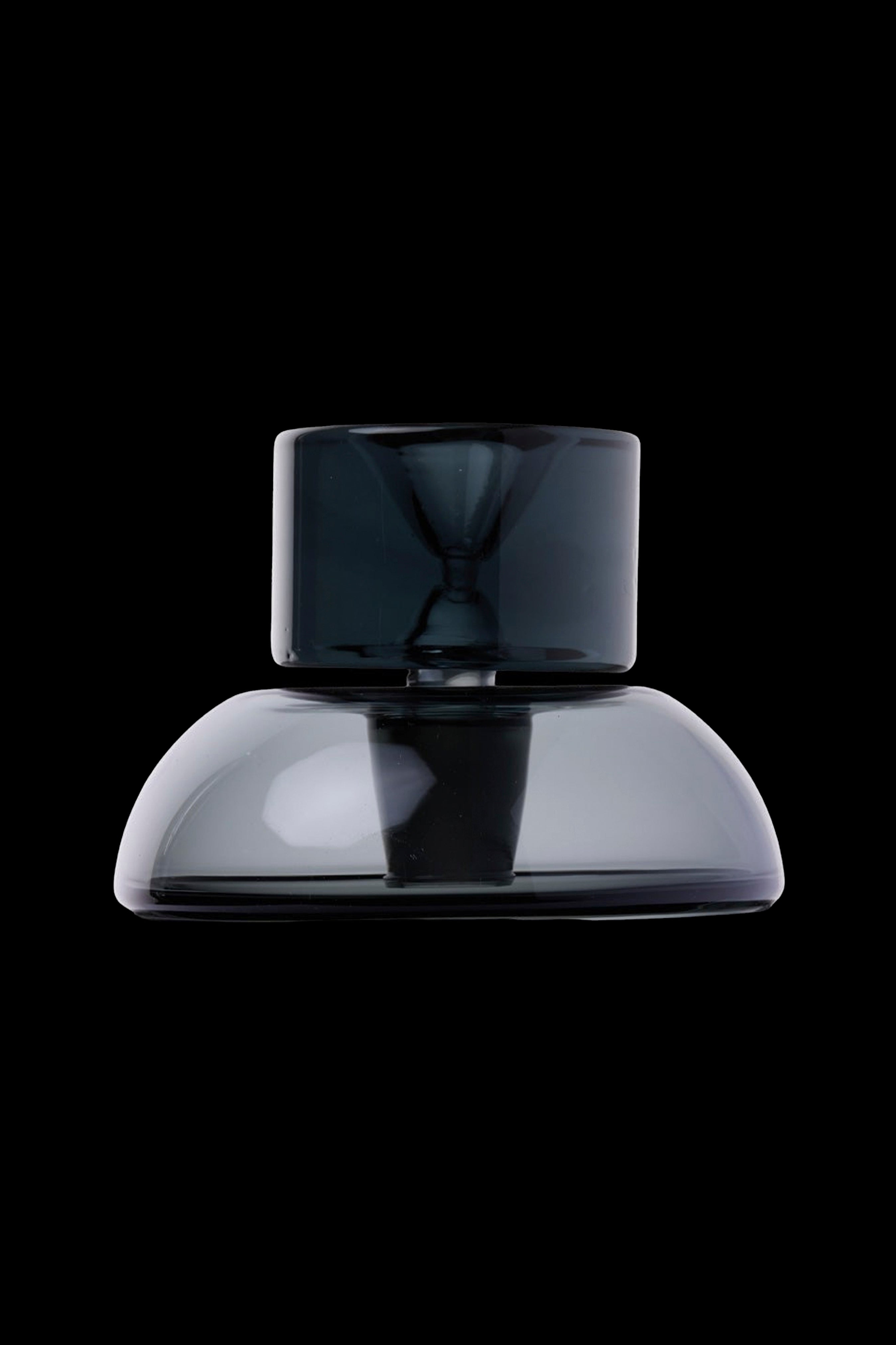 Sleek black cannabis water pipe against a dark background.