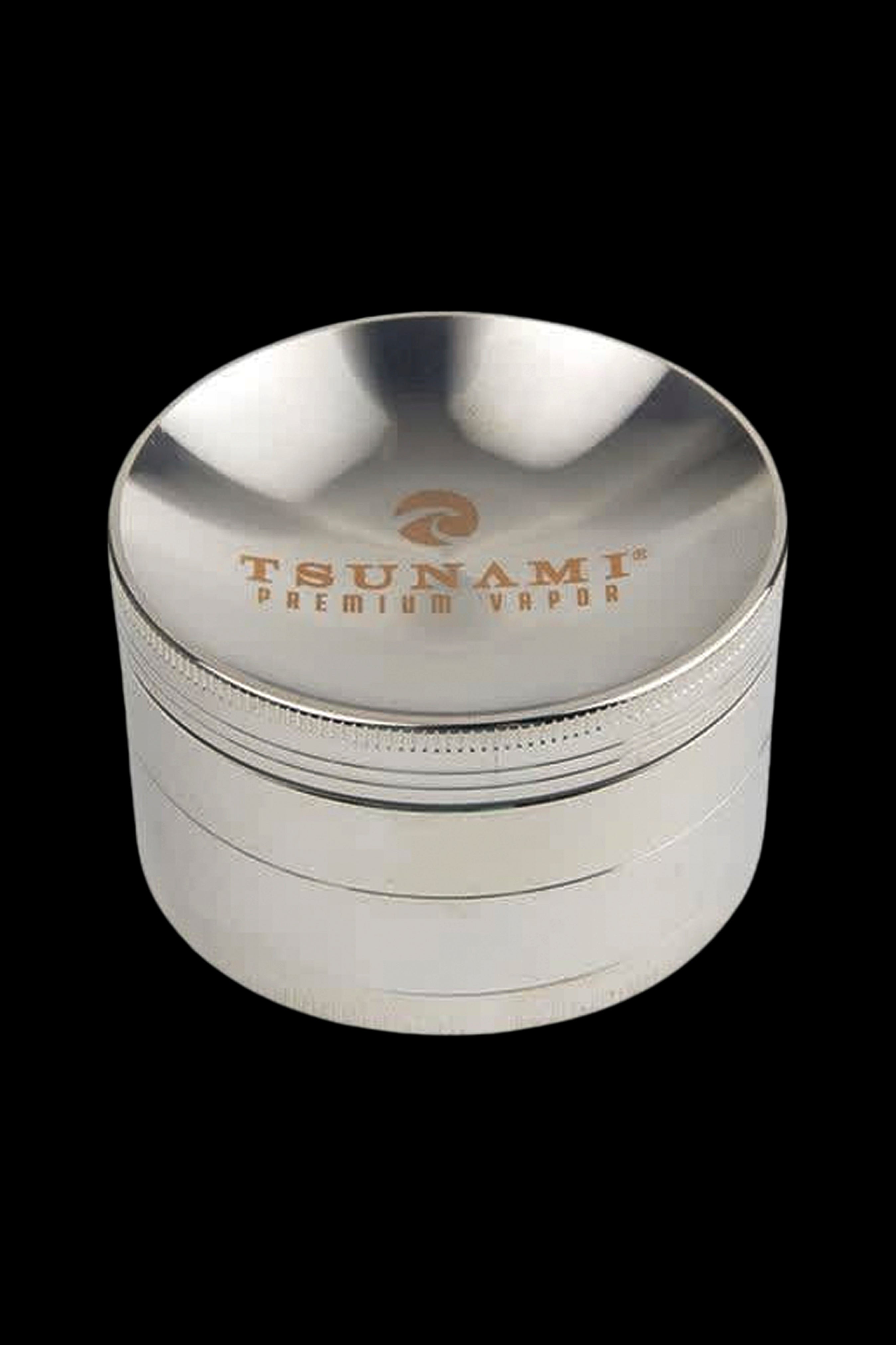 Silver four-piece cannabis grinder with “TSUNAMI PREMIUM VAPOR” engraved on the top.