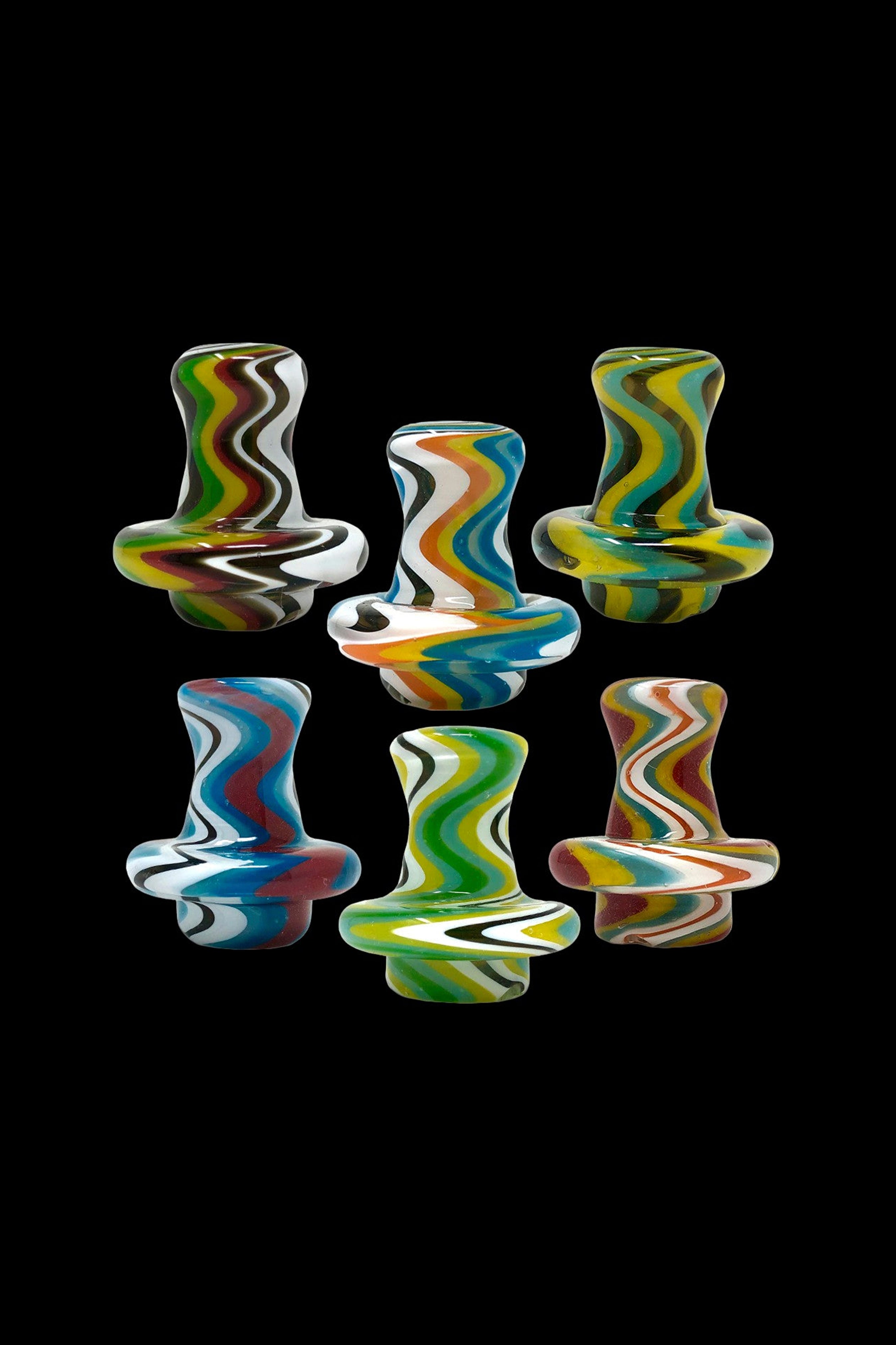 Colorful glass bubblers arranged on a black background.