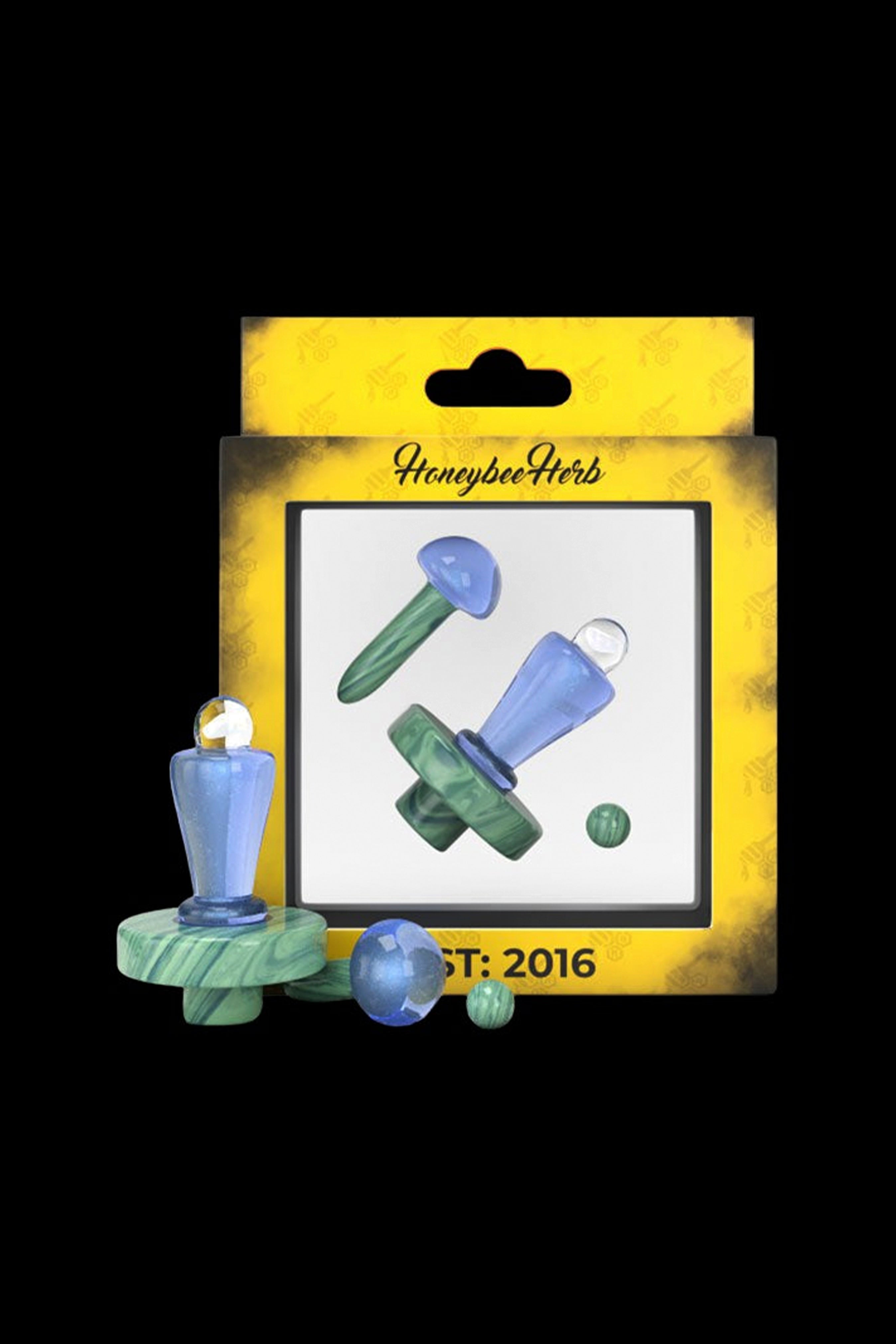 Retail packaging for colorful glass oil rigs and accessories, branded "HoneybeeHerb" and dated "2016."