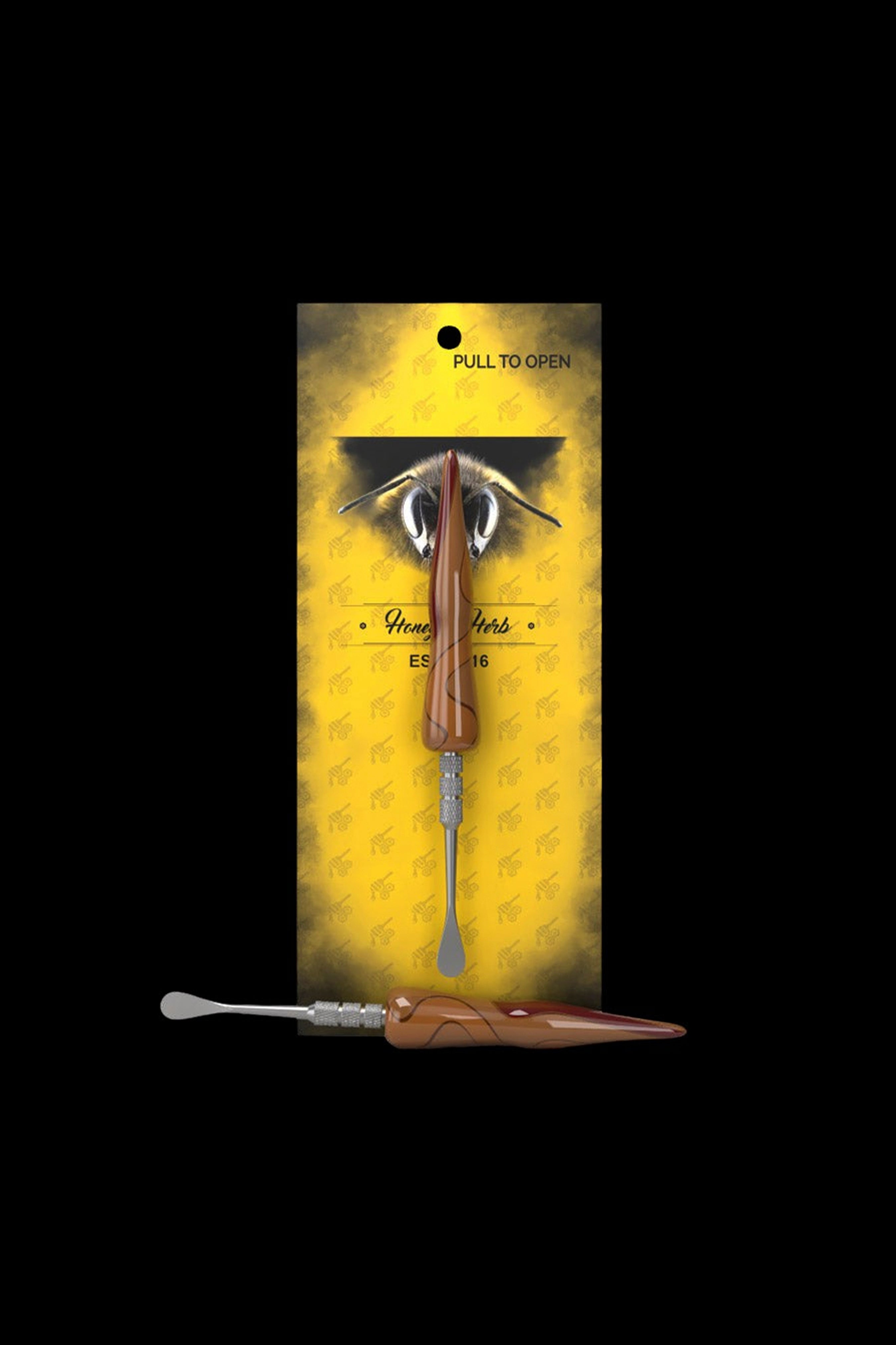 A cannabis dab tool with a brown and gold handle, packaged on a yellow card featuring a bee illustration and the text "Honey Herbs."