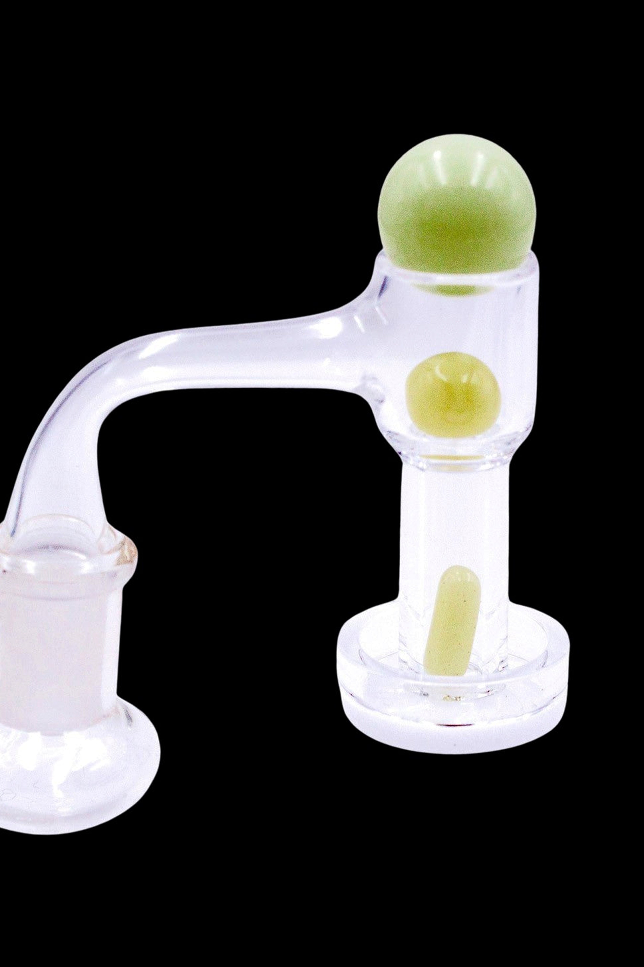 Clear glass dab rig with pale yellow accents, isolated on a black background.