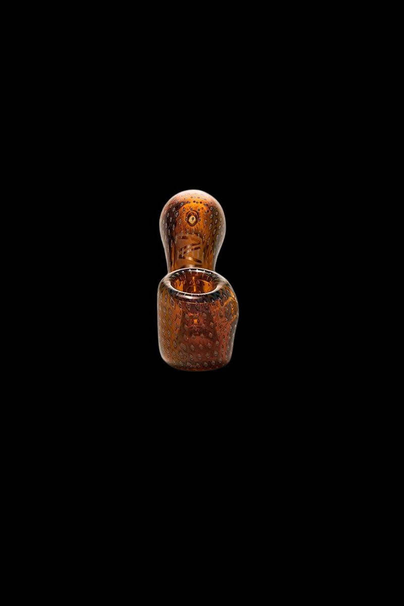 Amber glass pipe isolated on a black background.
