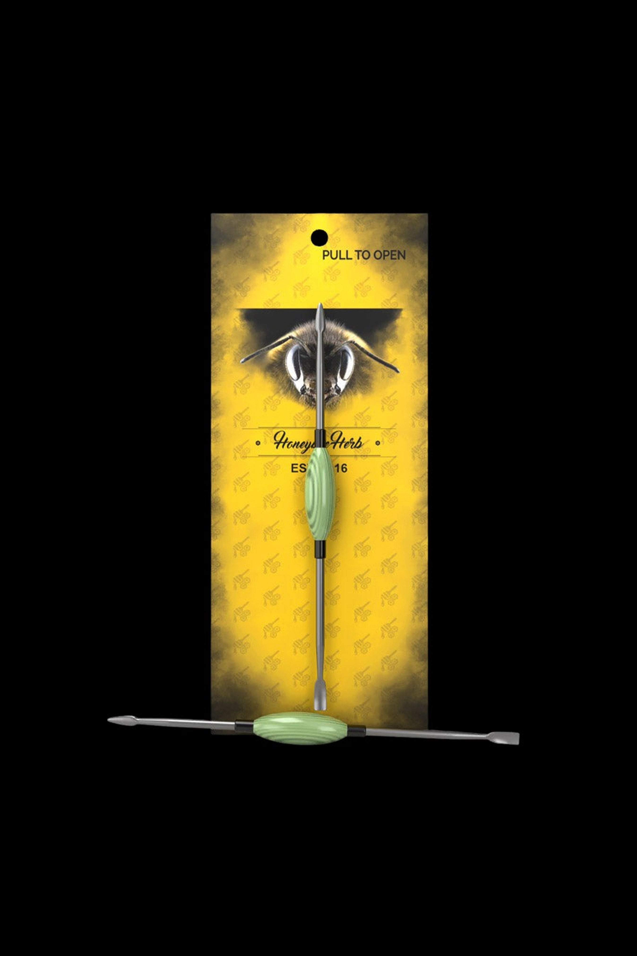 Packaging for “Honey Herbs” cannabis accessory, featuring a bee illustration and a dab tool inside.
