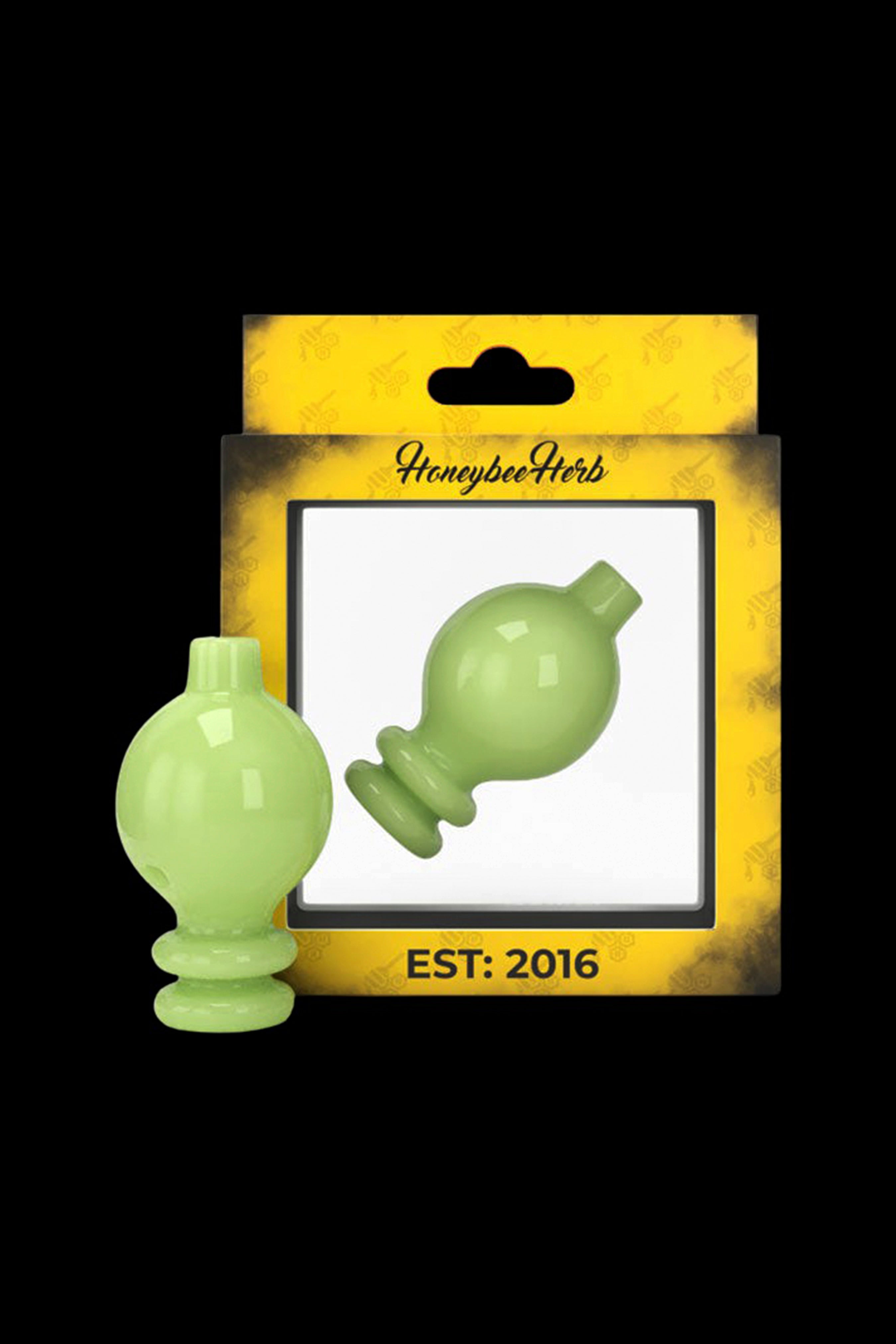 Green glass cannabis oil dome and carb cap set in retail packaging labeled “Honeybee Herb Est: 2016”.
