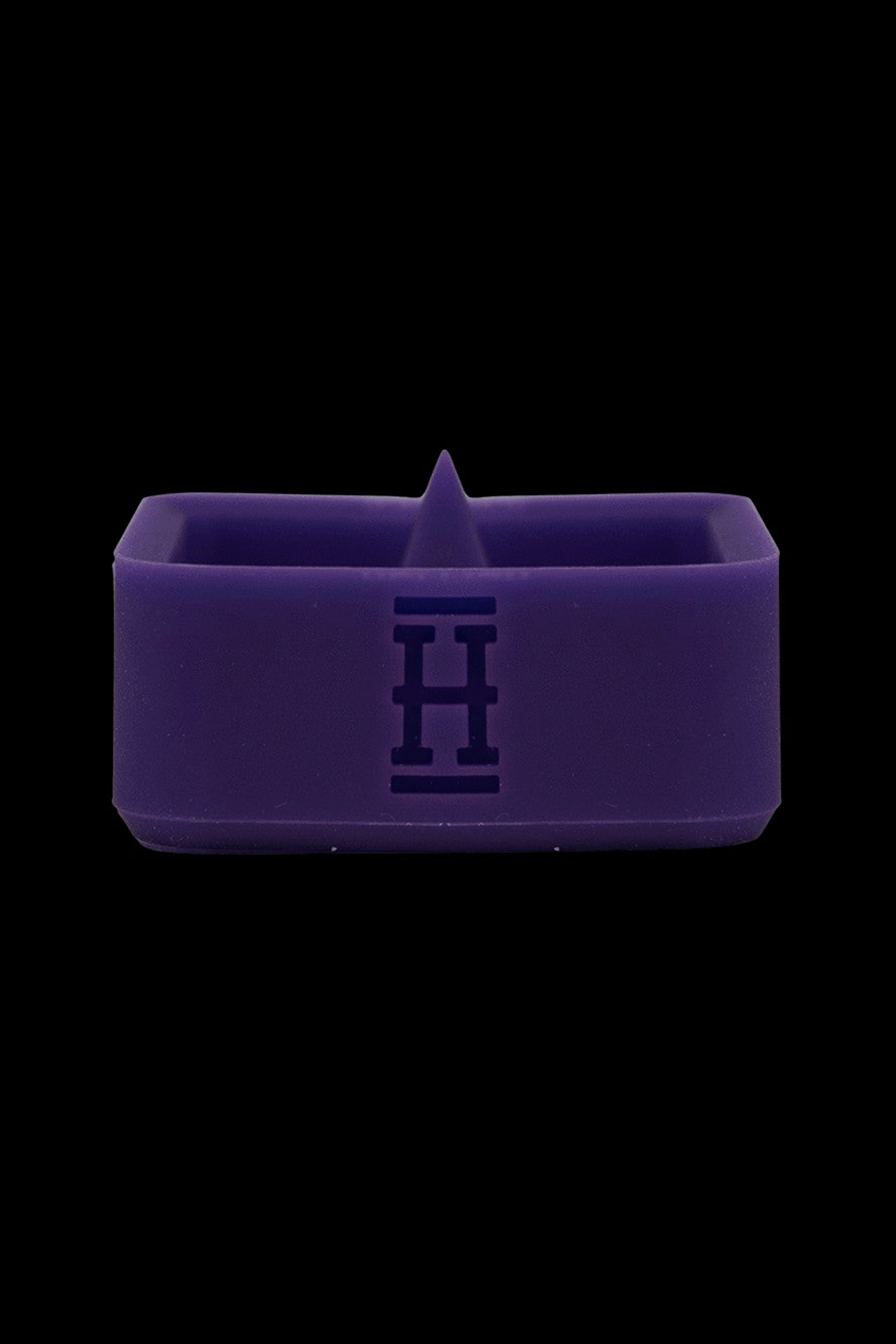 Purple silicone concentrate container with embossed logo.