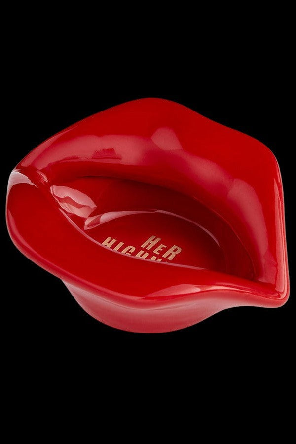 Red, glossy lip-shaped container with “HER” branding, likely for cannabis or related accessories.