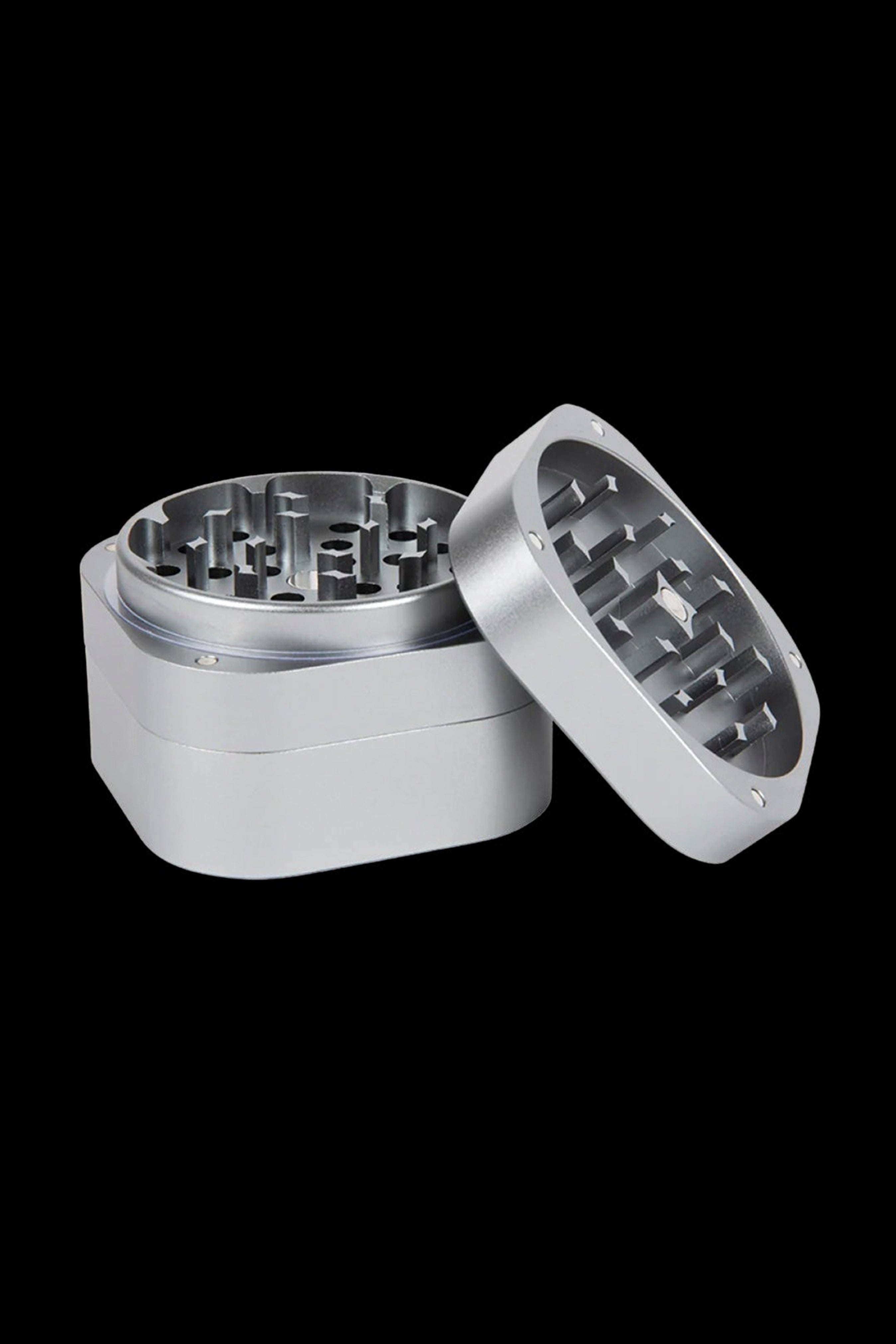 Silver cannabis grinder, open to reveal the multi-tiered grinding mechanism.