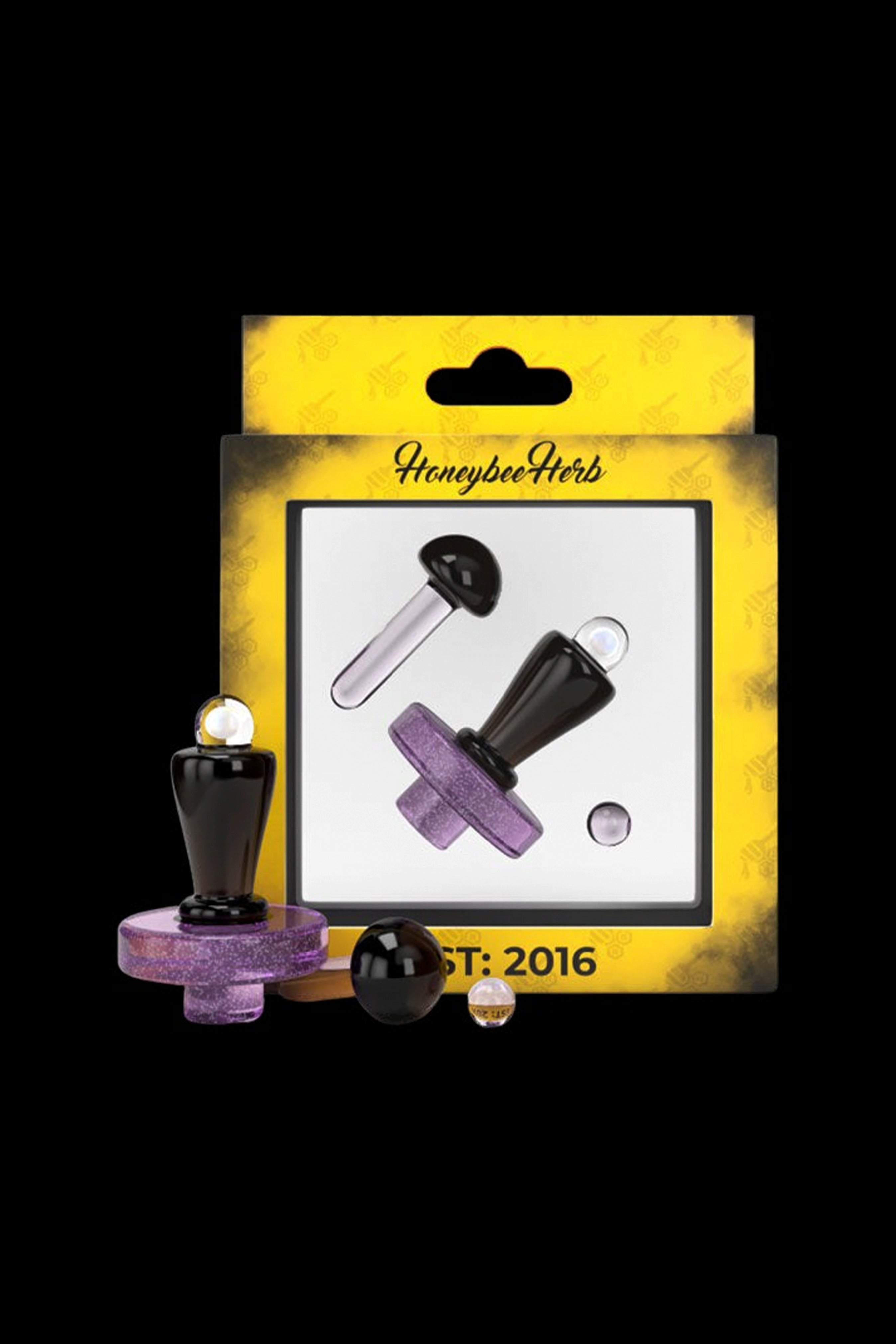 Packaged cannabis oil dab straws in black and purple with a “Honeybee Herb” logo, displayed with glass oil containers.