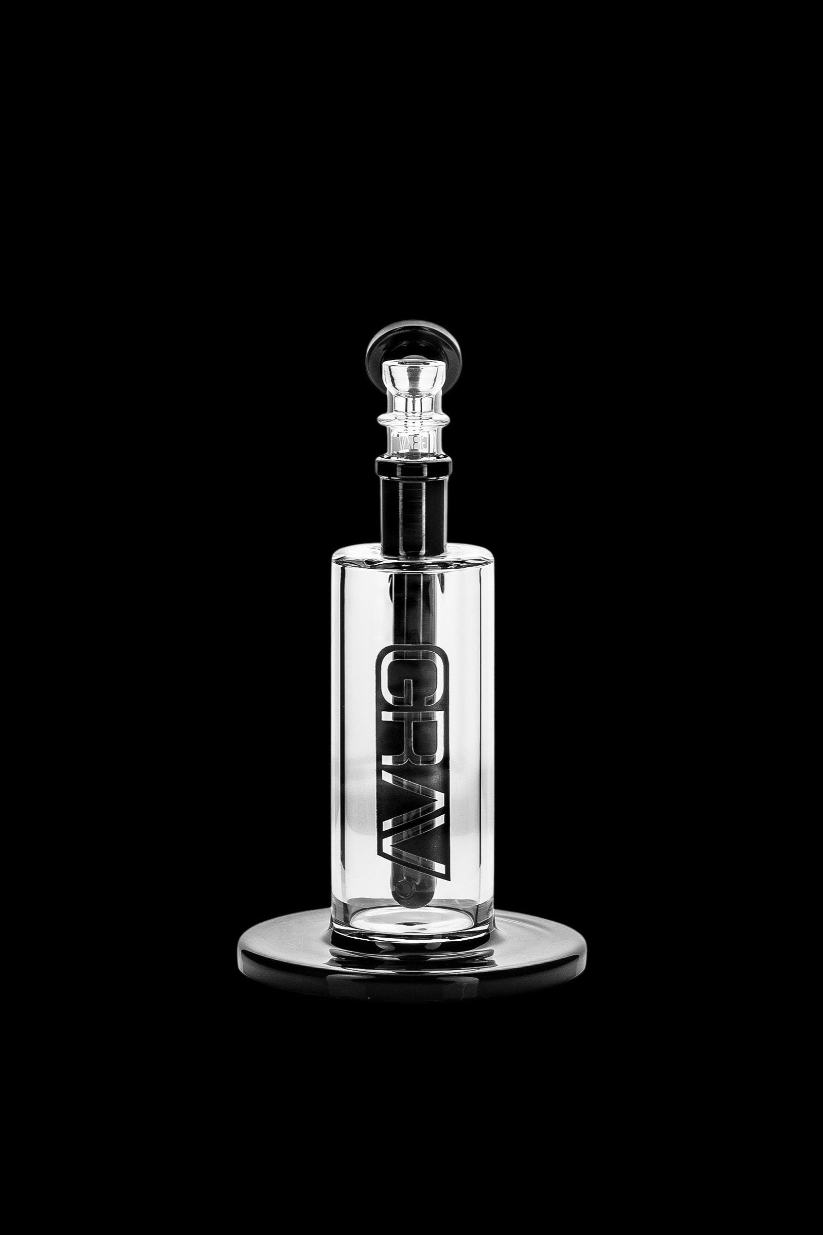 Clear glass oil rig with “GRAV” text vertically etched on the body, isolated on a black background.