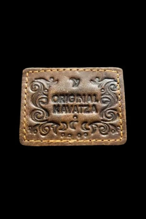 Embossed leather patch with ornate swirls and the text “Original Navatza.”