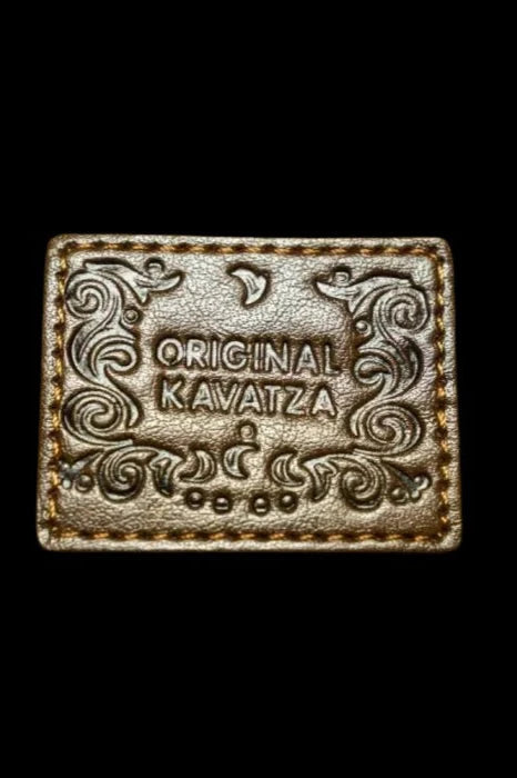 Embossed leather patch with ornate scrollwork and the text “ORIGINAL KAVATZA” against a black background.