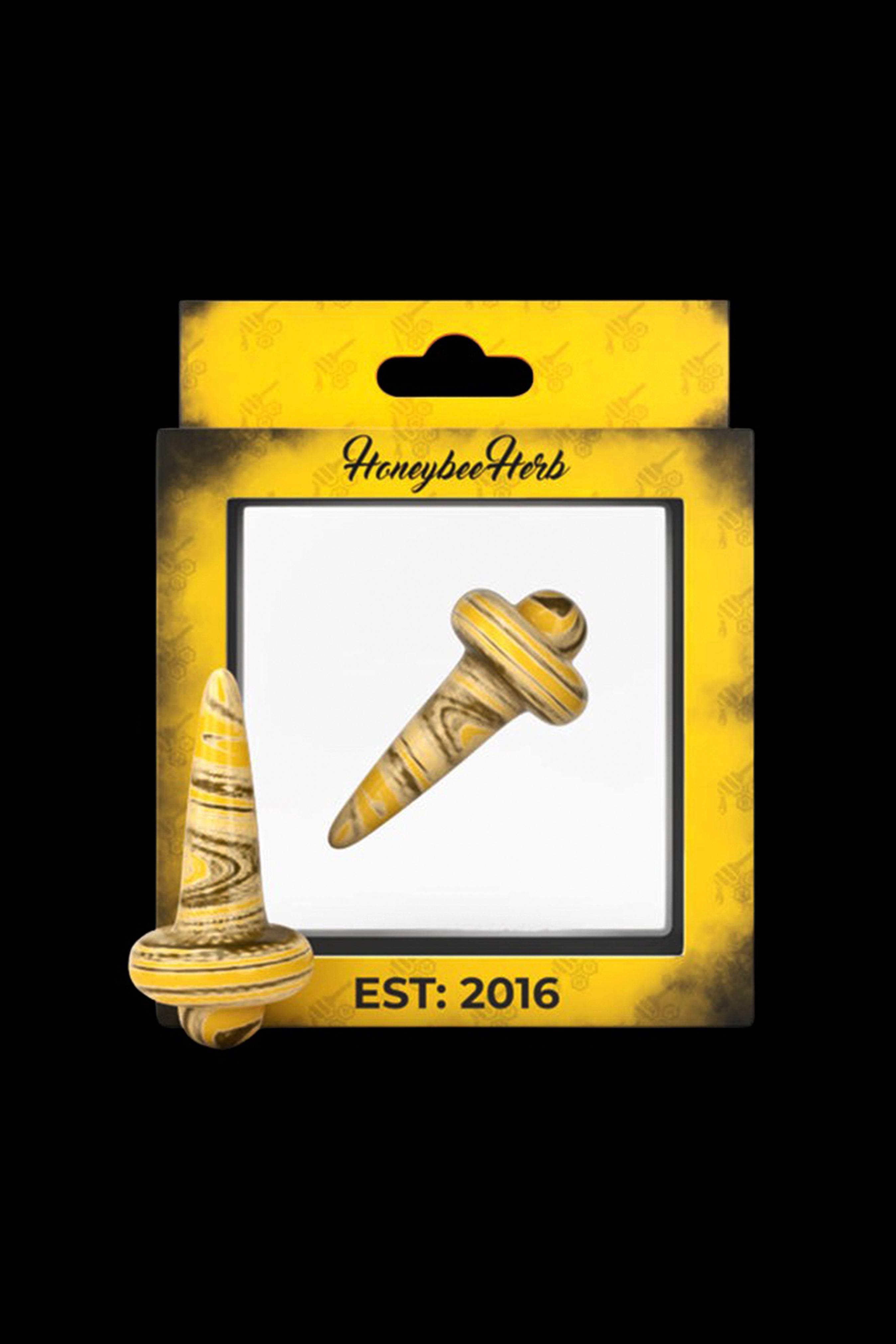 A packaged, carved stone cannabis dab tool with a bee-themed "Honeybee Herb" label and "EST. 2016" at the bottom.