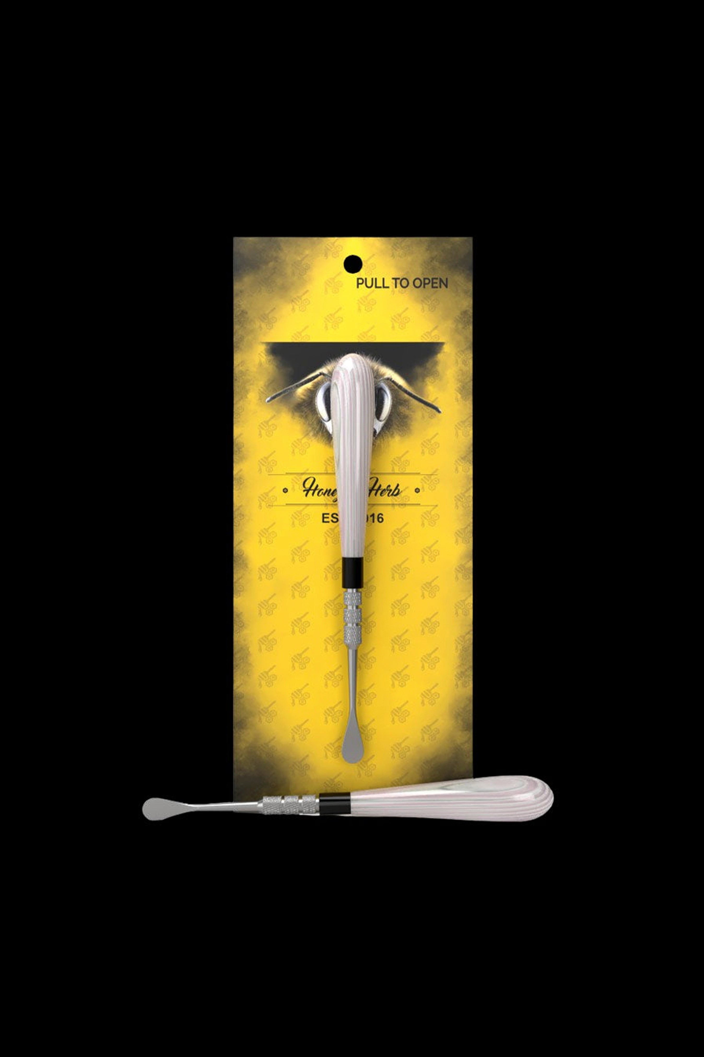 Vertical product shot of the Honeybee Herb Classic Dab Tool showing a pink-handled metal dab tool centered on yellow branded backing.