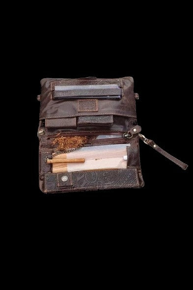 Leather case open displaying cannabis products, including a pre-roll, flower, and rolling papers, against a black background.
