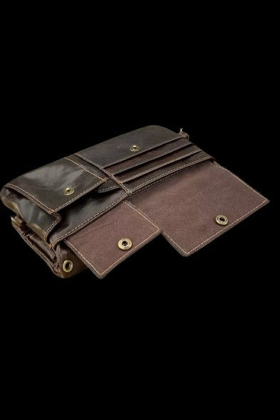 Brown leather cannabis rolling wallet, open to reveal multiple pockets and compartments.
