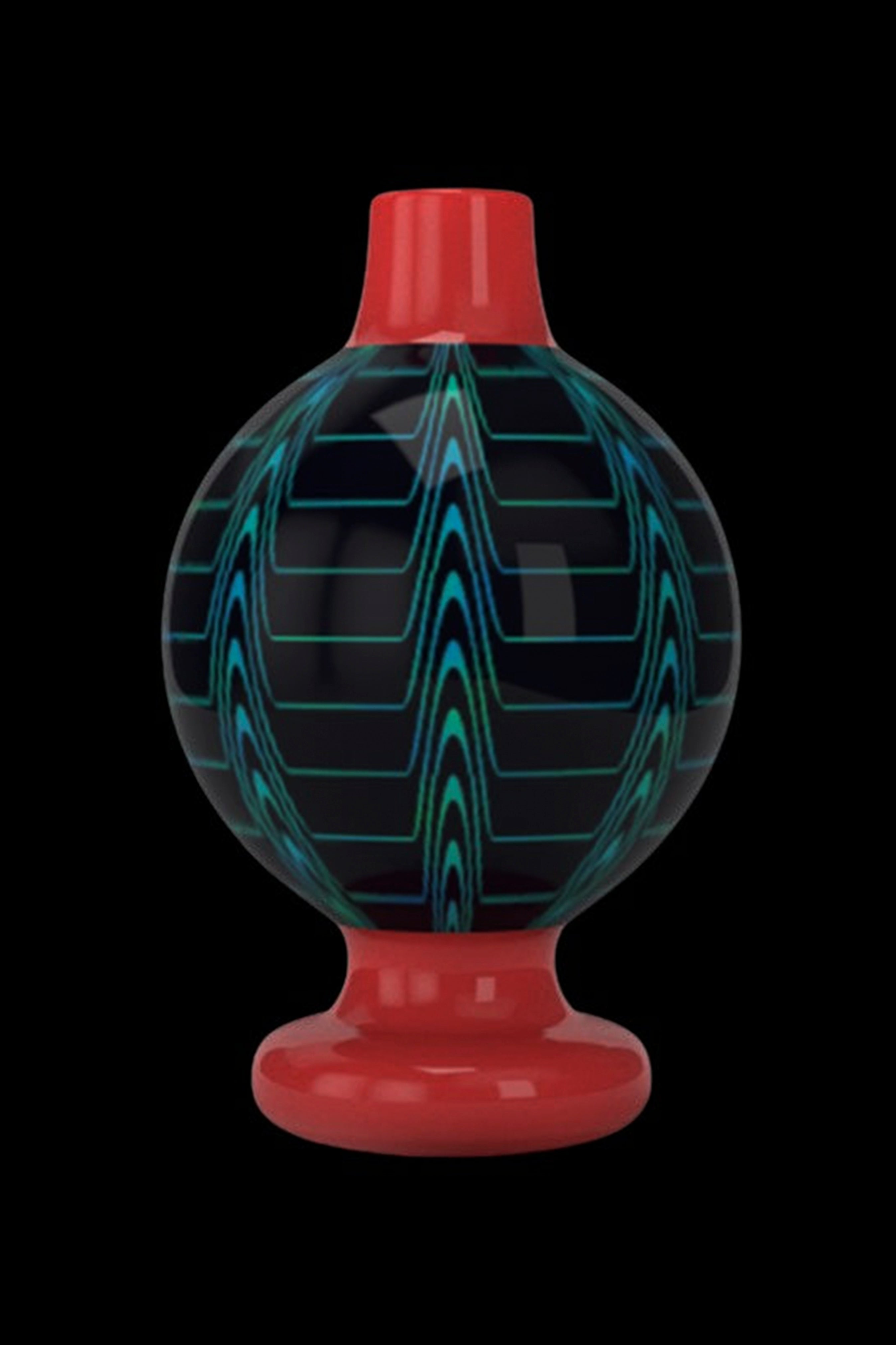 Red glass cap with teal geometric pattern for use with a cannabis dab rig.