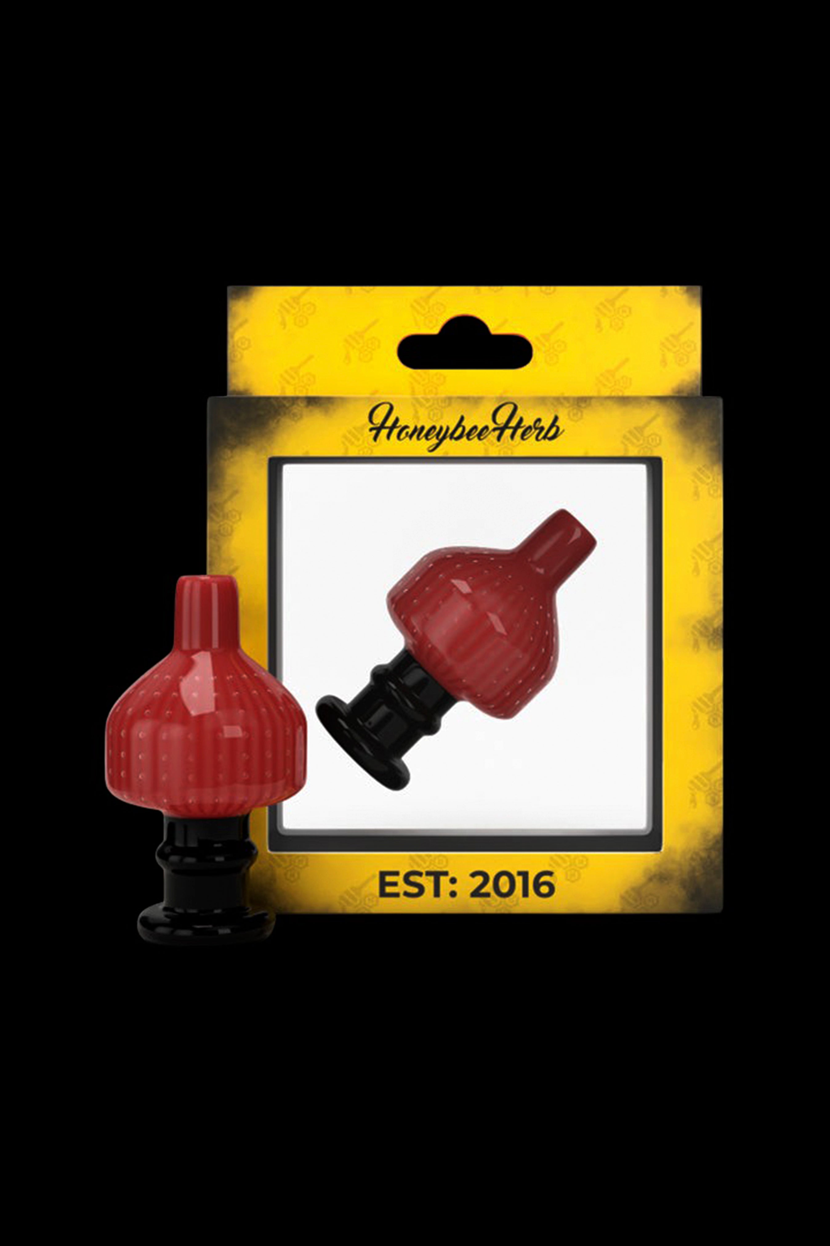 Red glass cannabis oil rig bubbler attachment on yellow packaging labeled "HoneybeeHerbs EST: 2016".