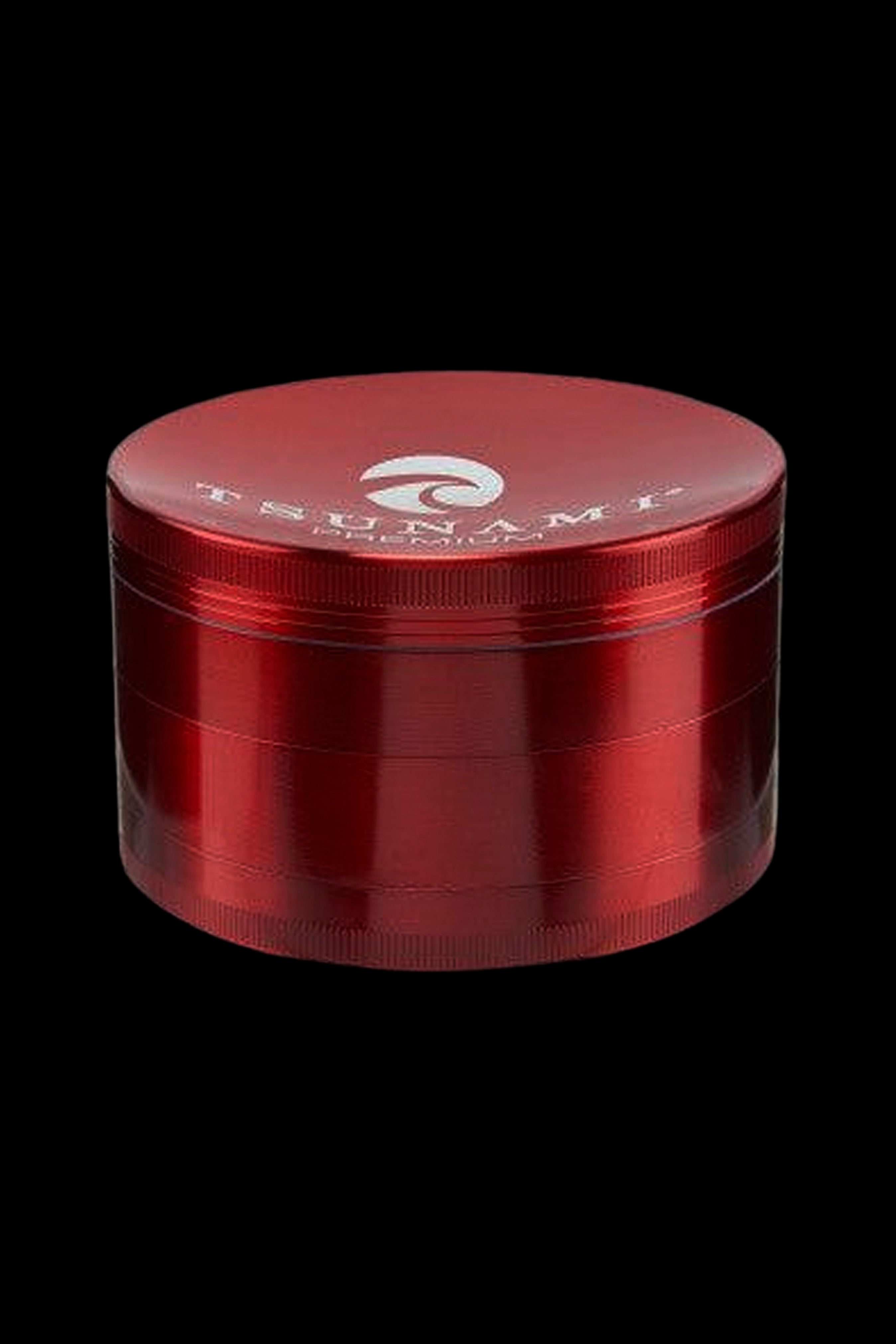 Red four-layer cannabis grinder with branded lid.