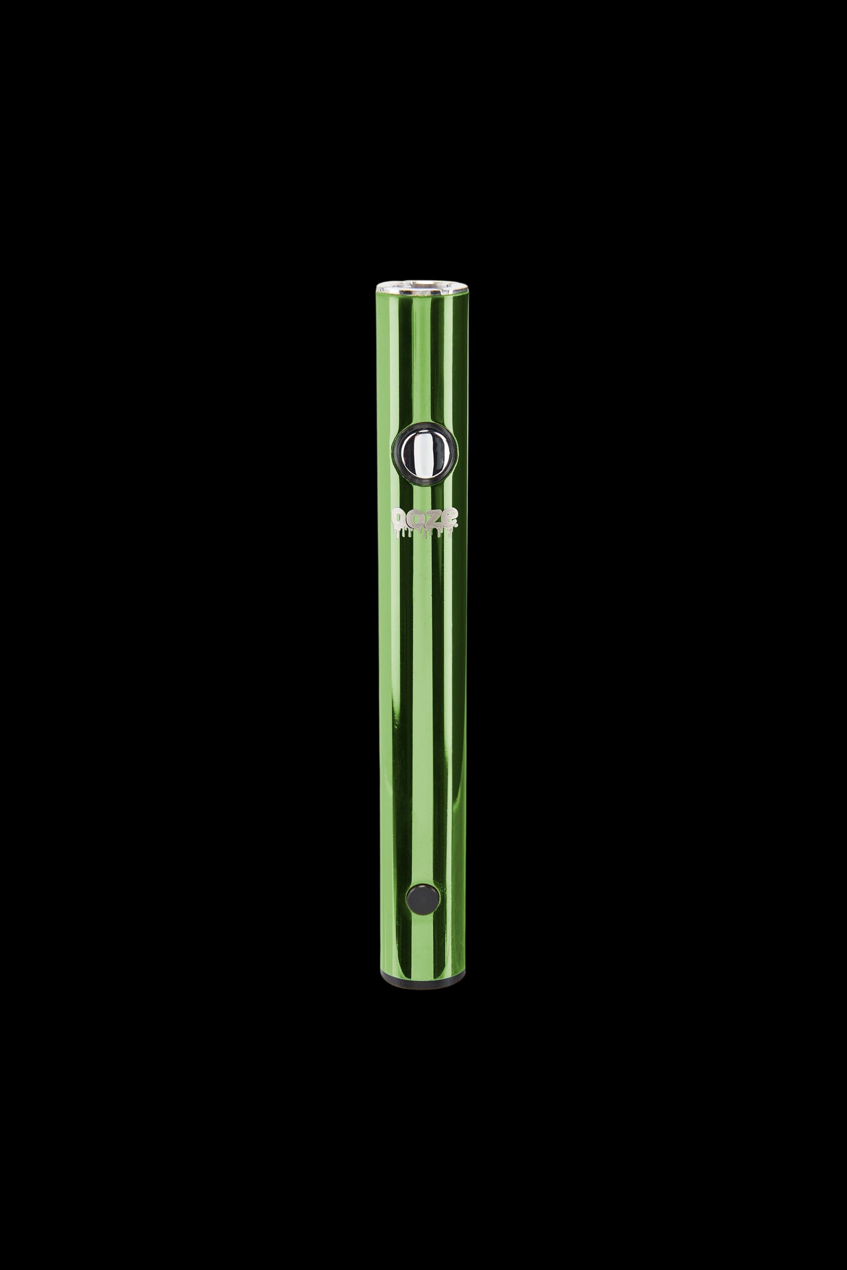 Green and silver cannabis vape pen against a black background.