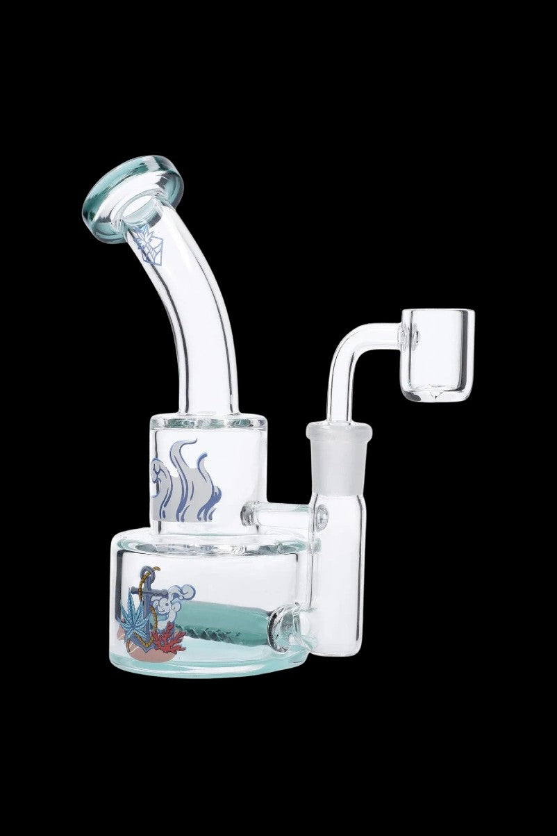 Three-quarter view of the teal Cabana Cannabis Co. Ahoy Dab Rig against a black background, showing its curved mouthpiece and decorated base.