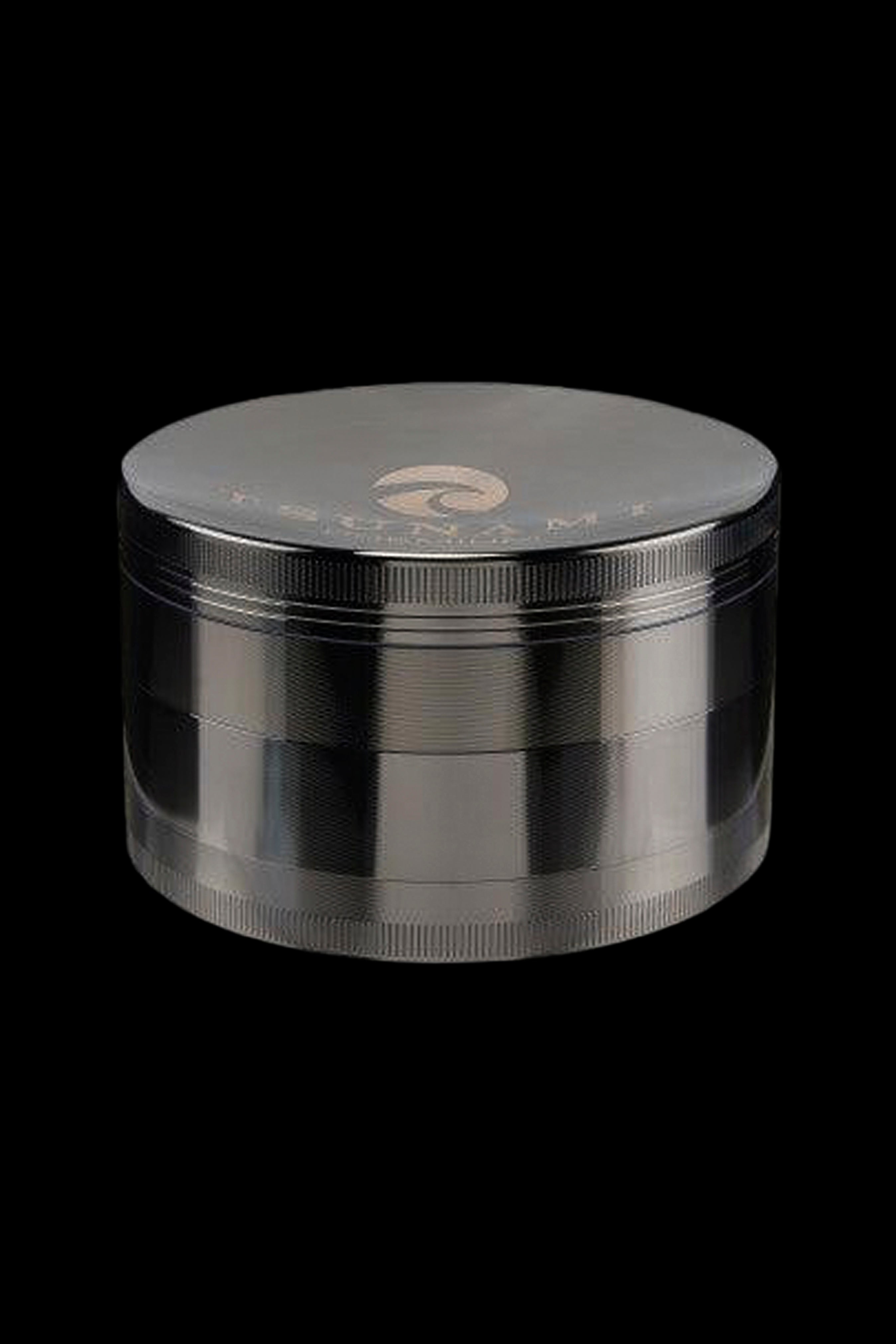 Silver four-piece cannabis grinder on a black background.