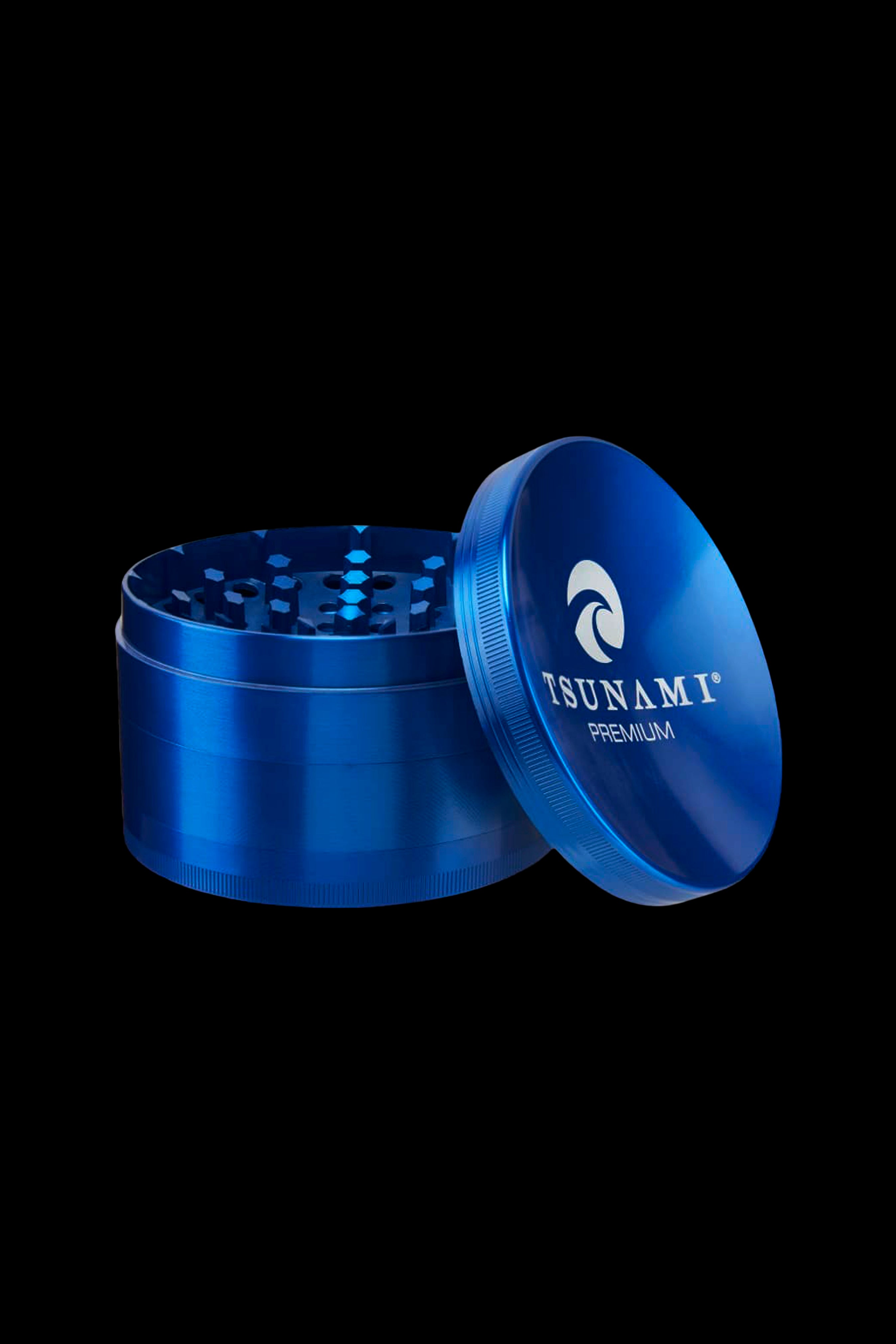 Blue metal cannabis grinder with lid open, displaying internal grinding teeth.