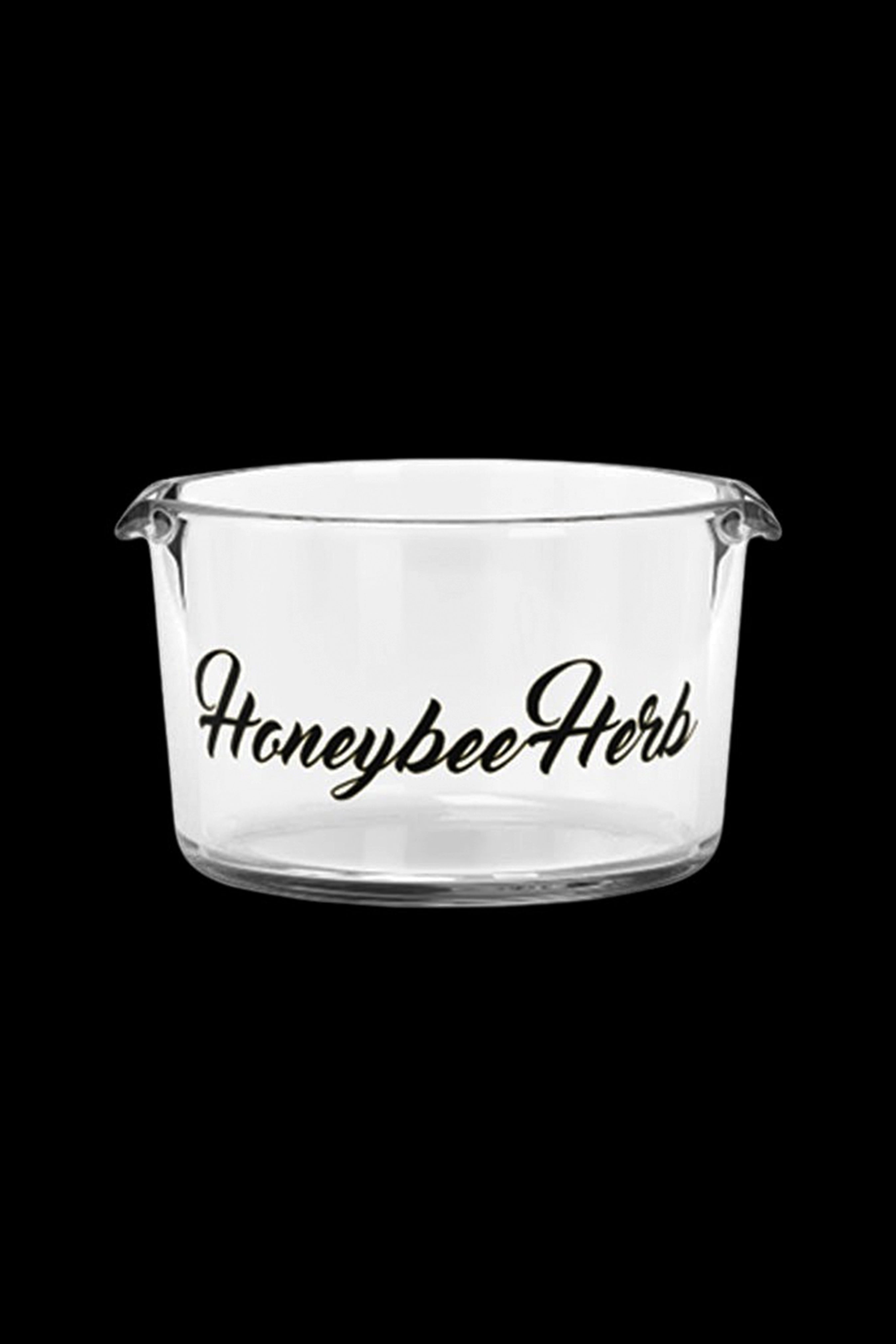 Clear glass cannabis storage jar with “Honeybee Herb” script.