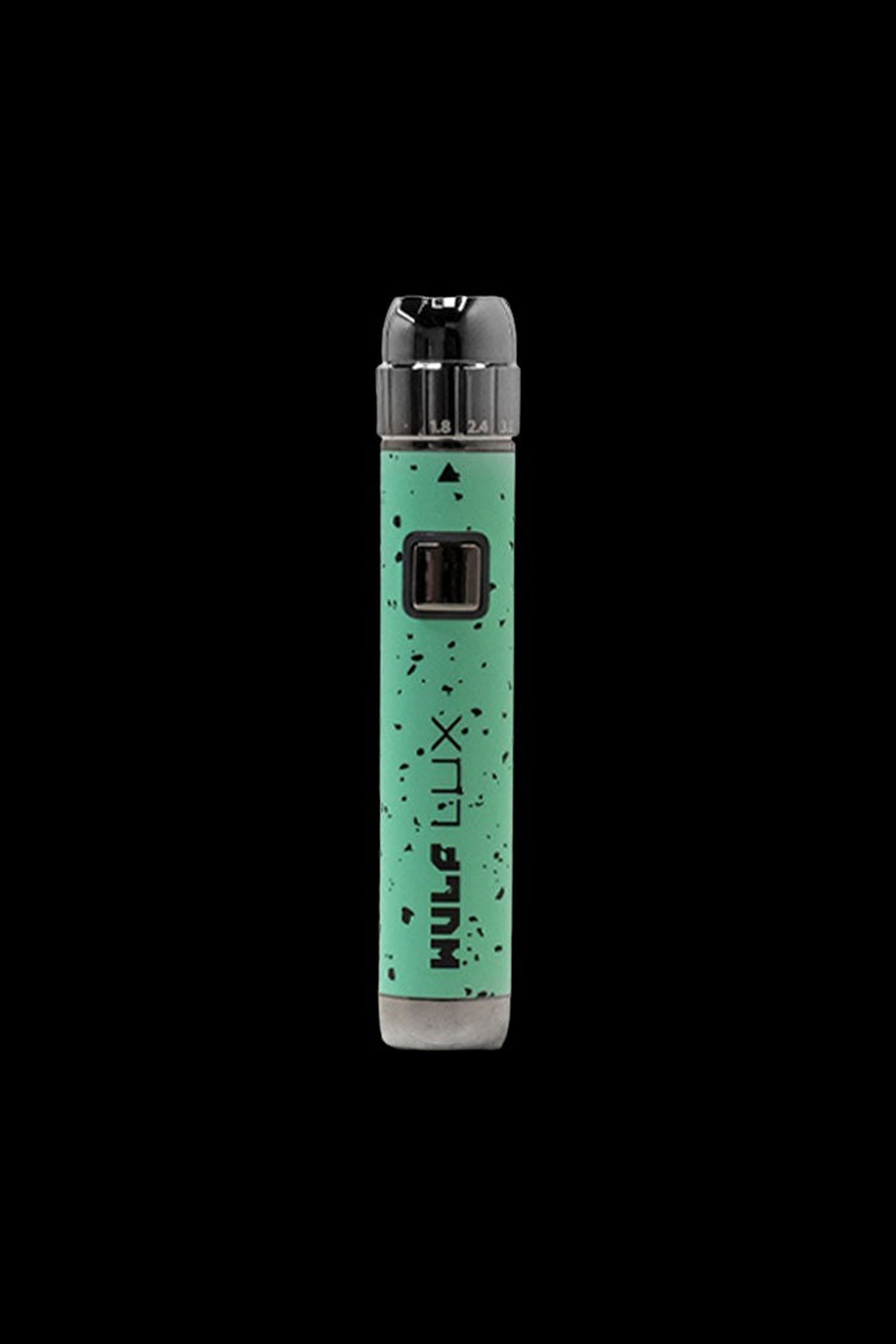 Green cannabis vape pen with “XLUX” branding against a black background.
