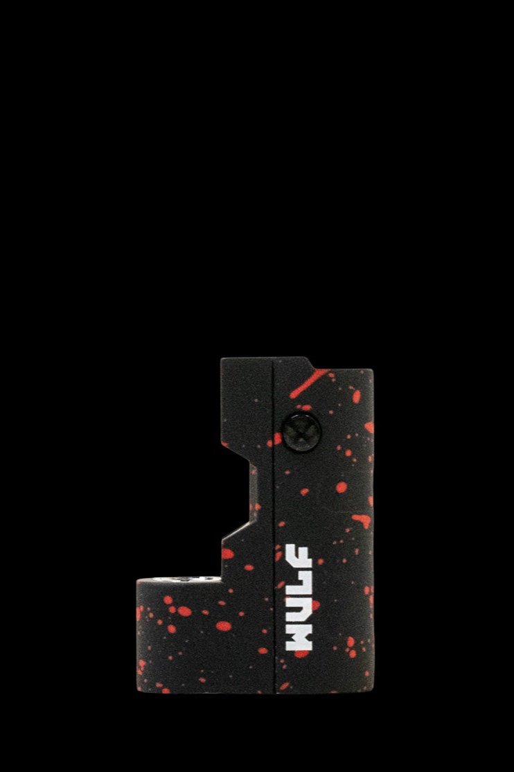 Black cannabis pipe with red splatter design, branded “NUDE”.