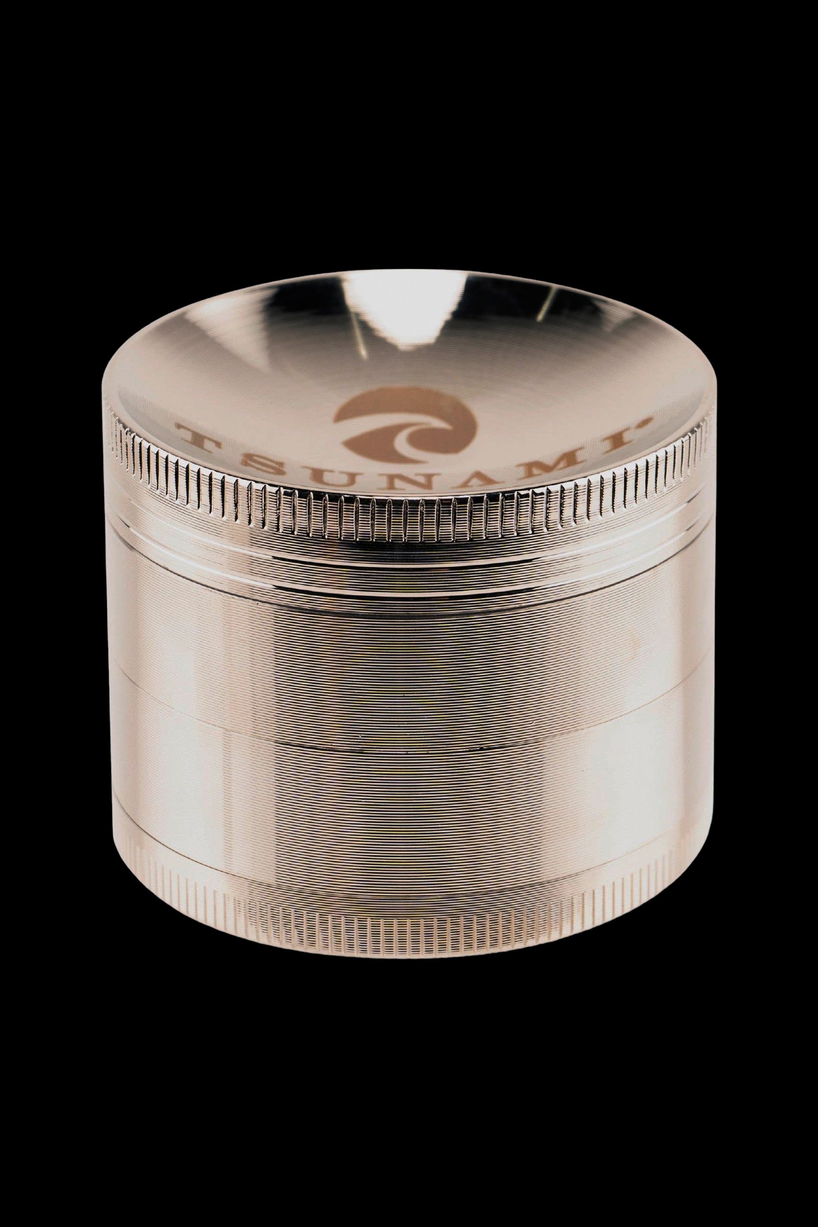 Clear four-piece cannabis grinder with metallic threading and a branded top.