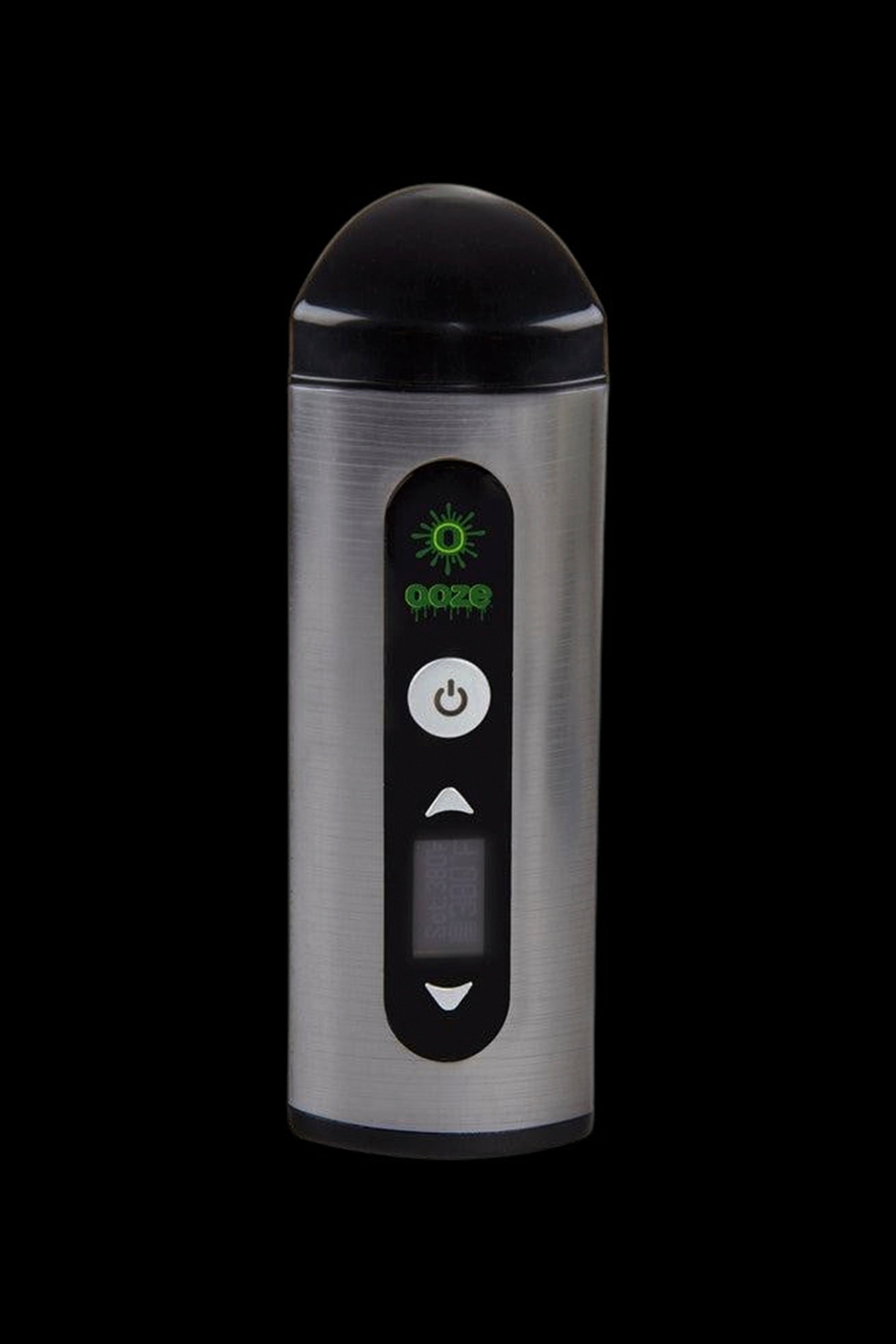 Silver cannabis vaporizer with digital display and controls against a black background.