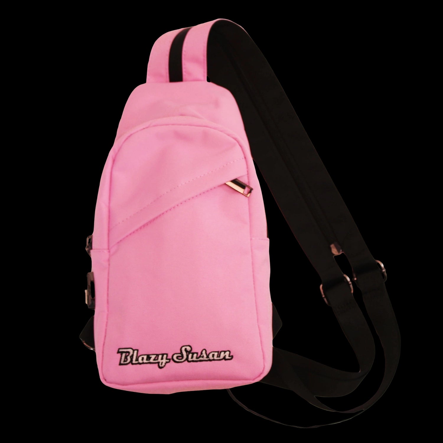 Angled front view of the pink Blazy Susan Over-The-Shoulder Bag - Pink showing its curved top, diagonal front pocket seam, embroidered logo and black strap against a black background