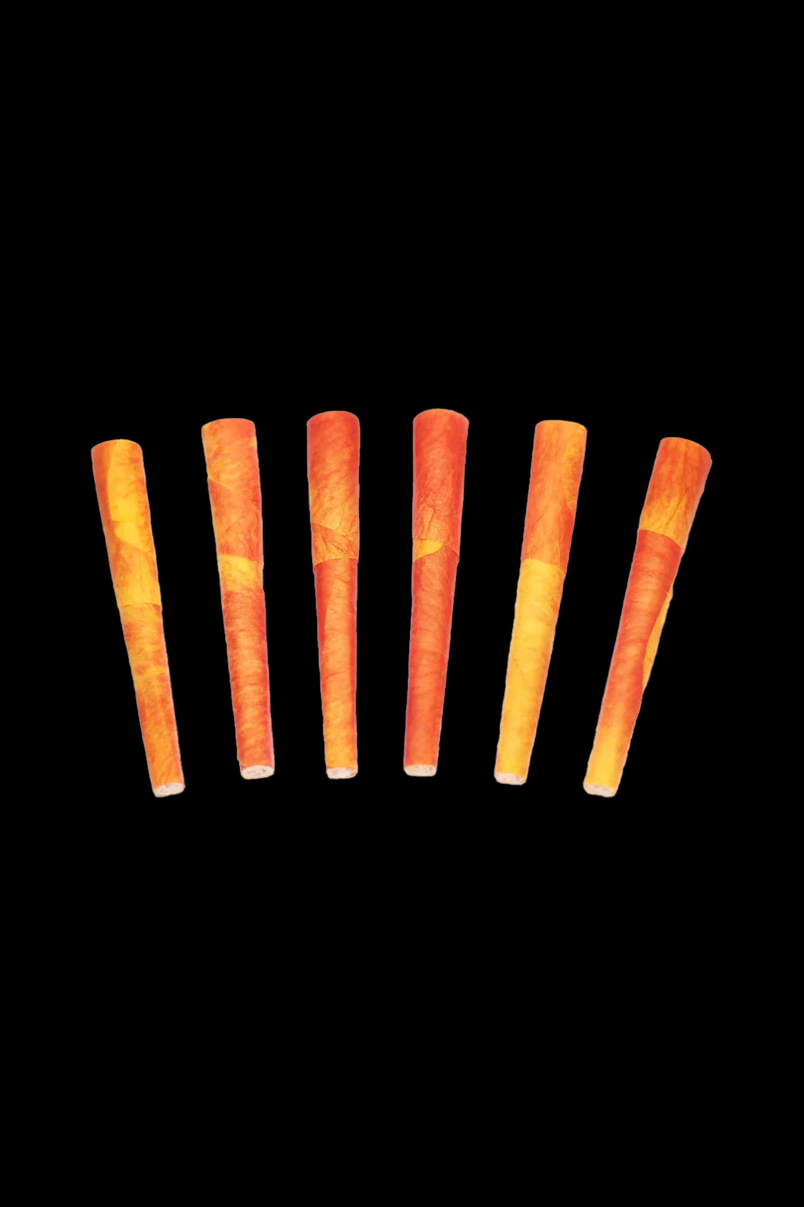 Six lit cannabis cigarettes against a black background.