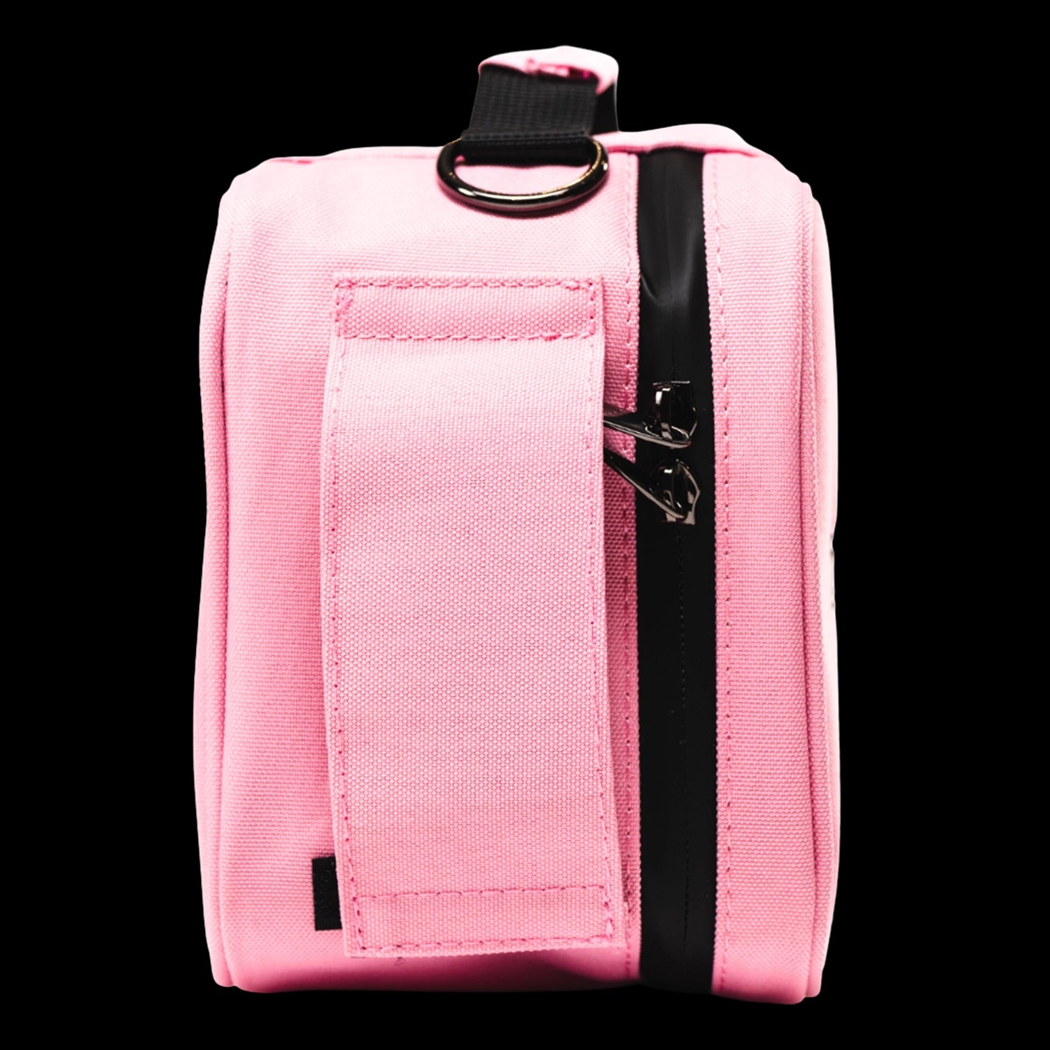 Close-up side view of a pink Blazy Susan Stash Bag showing a vertical black zipper, metal zipper pulls and a stitched fabric strap with a metal D-ring.