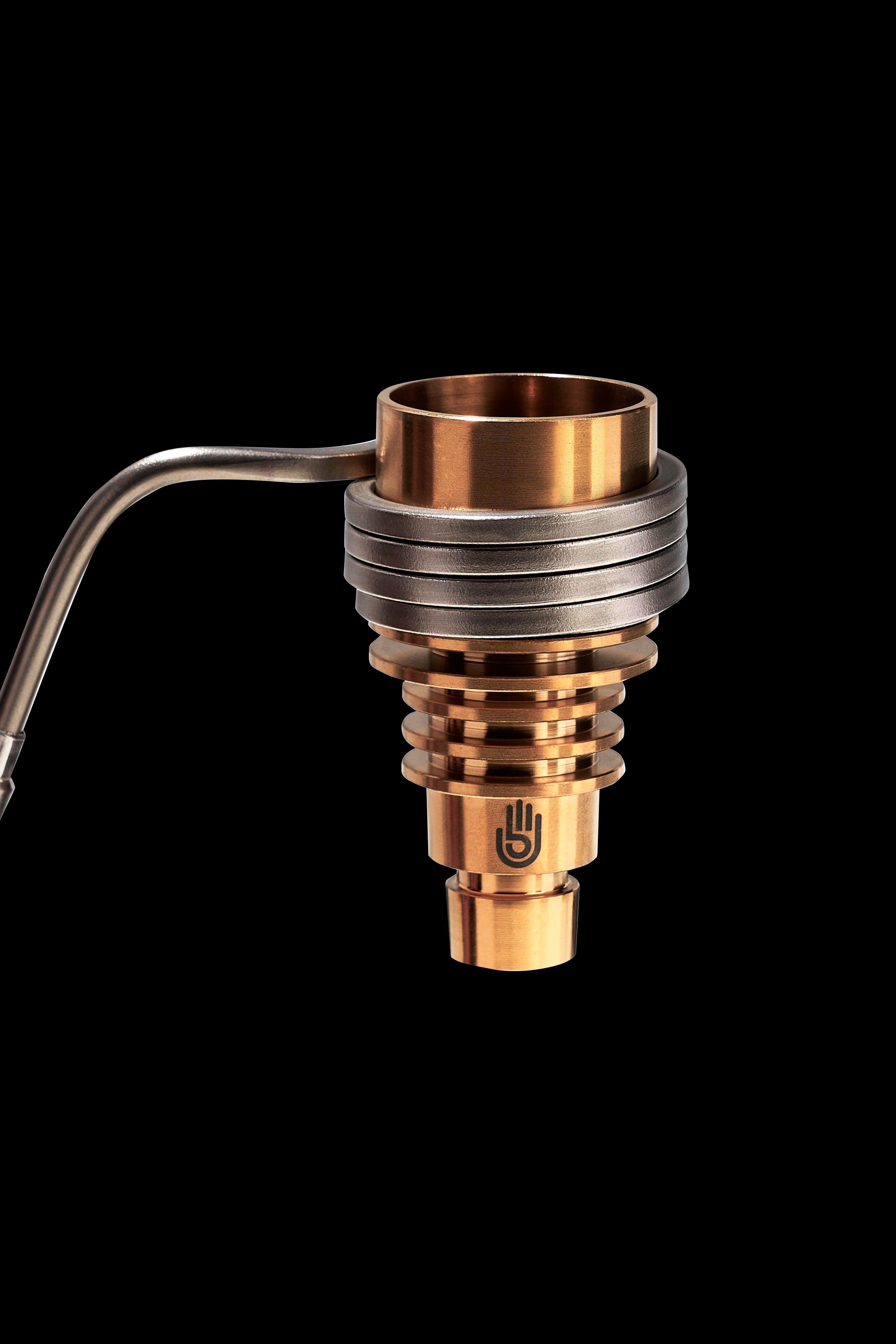 Bronze cannabis concentrate vaporizer coil with a glass carb cap and metal tubing, isolated on a black background.