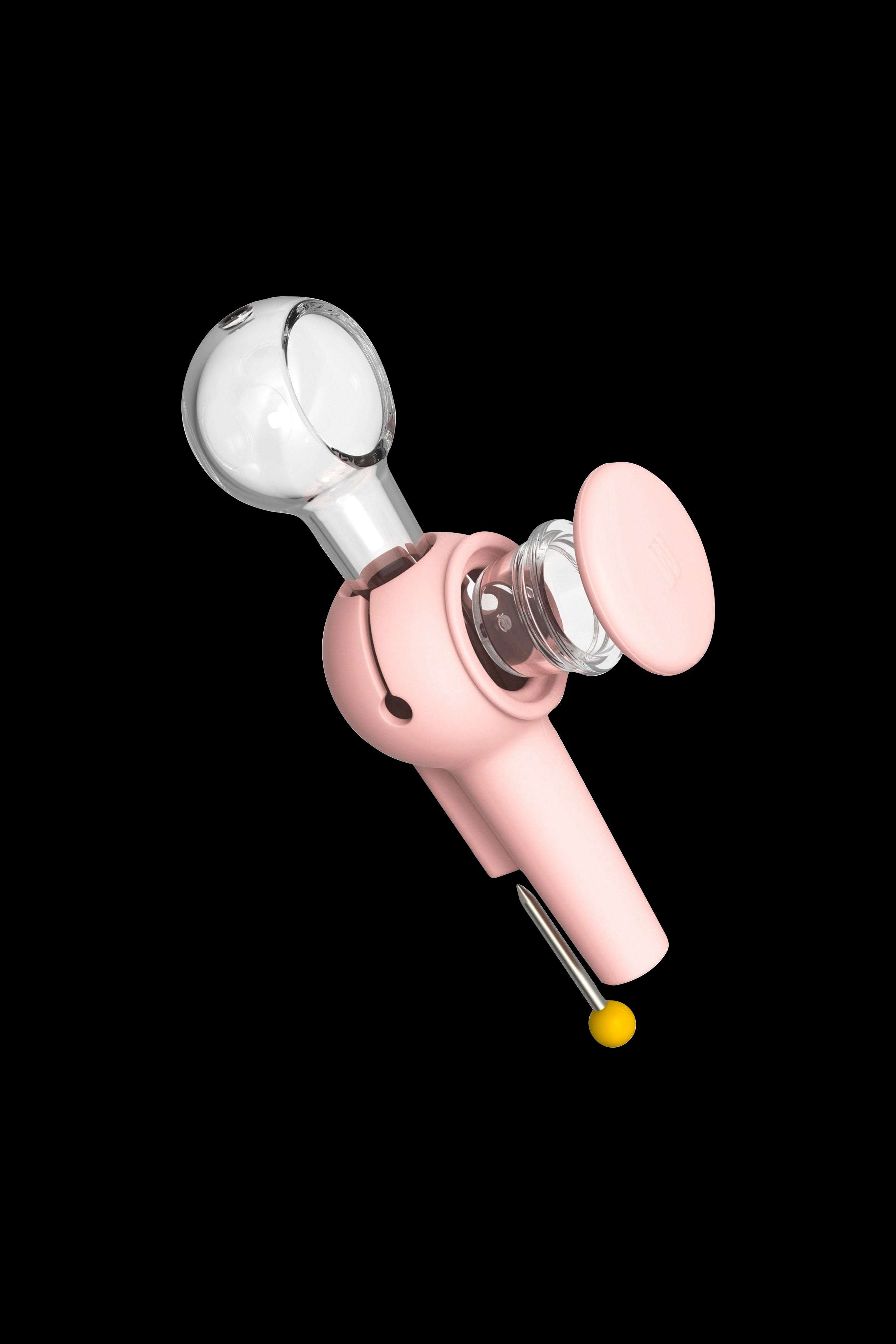 Pink silicone dab rig with glass bowl and carb cap, isolated on a black background.