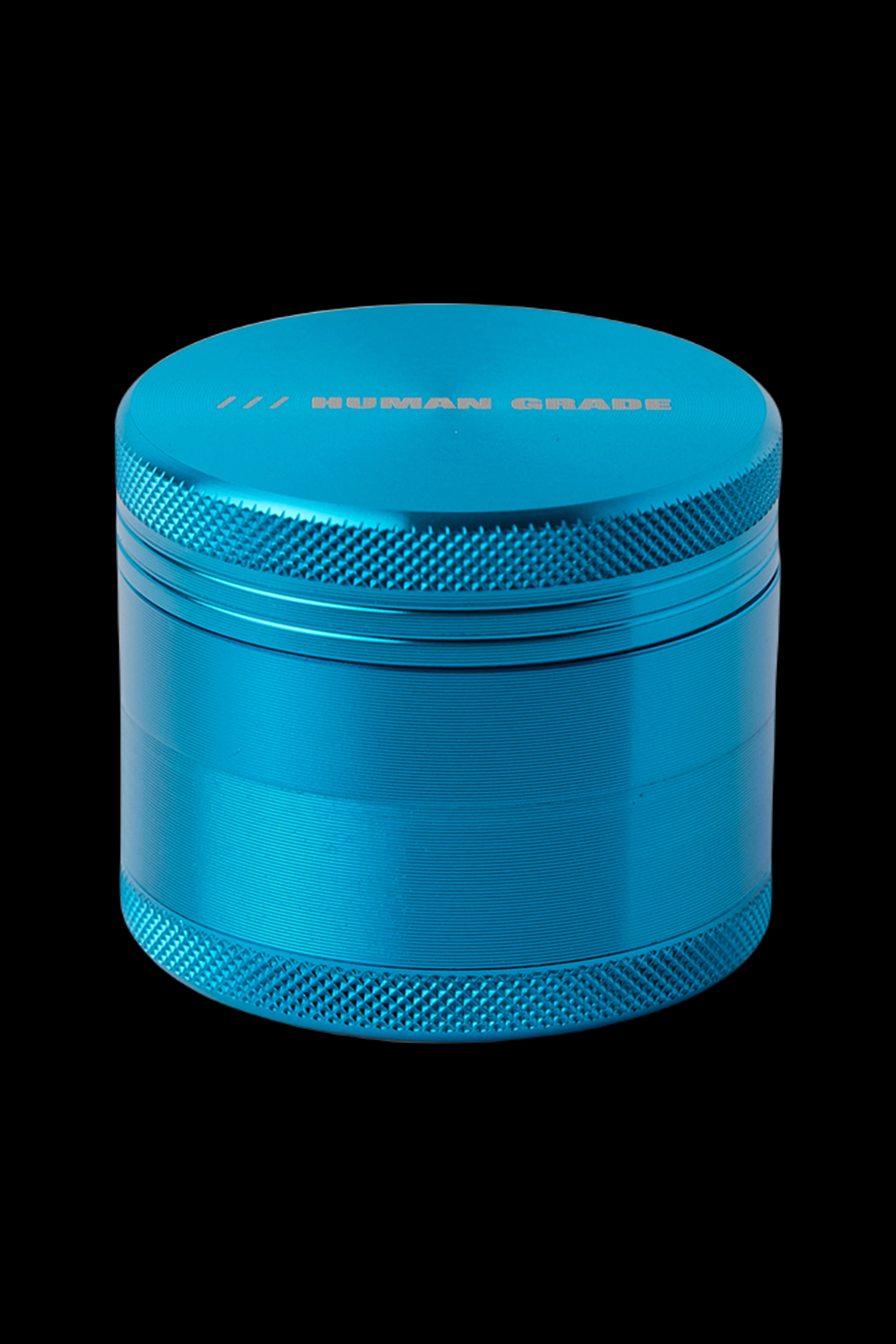 Blue four-piece metal herb grinder with “HUMAN GRADE” text.