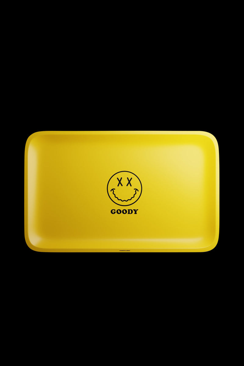 A top-down view of the Goody Glass Yellow Big Face Rolling Tray, featuring a large circular graphic on a yellow surface.