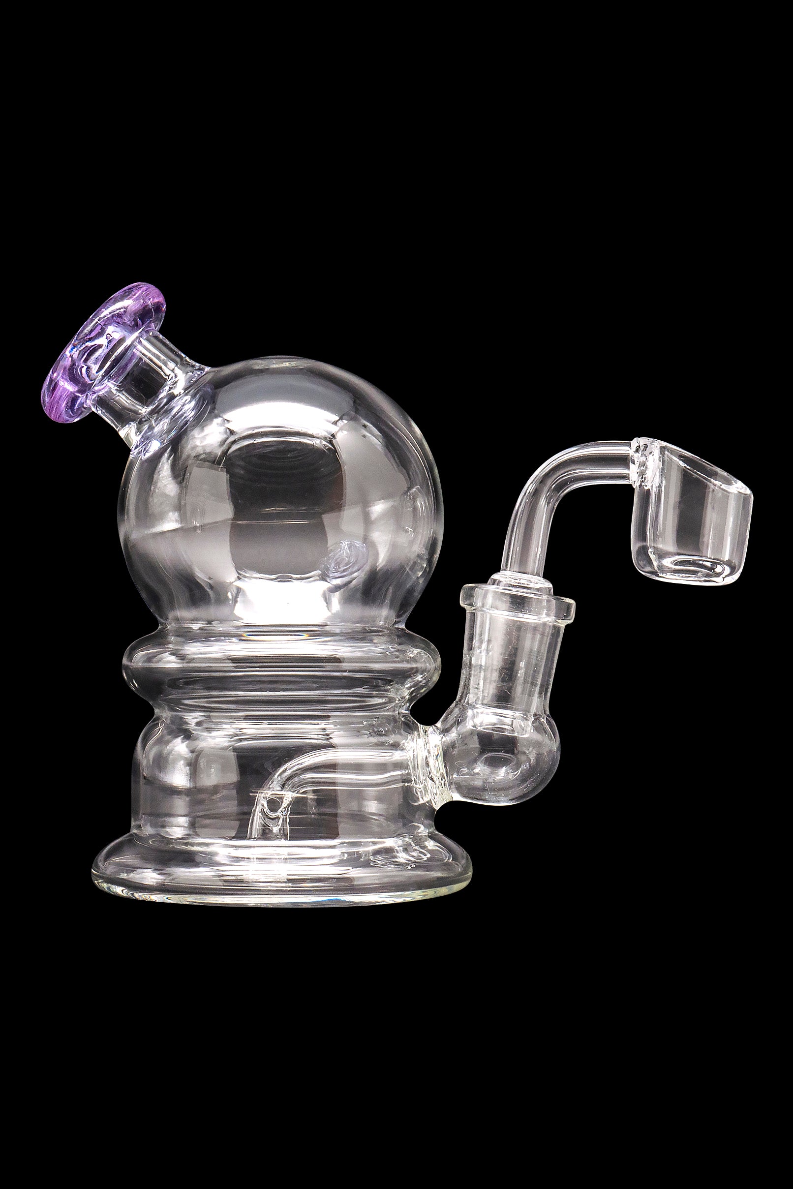 Clear glass dab rig with a spherical chamber and quartz banger, isolated on a black background.