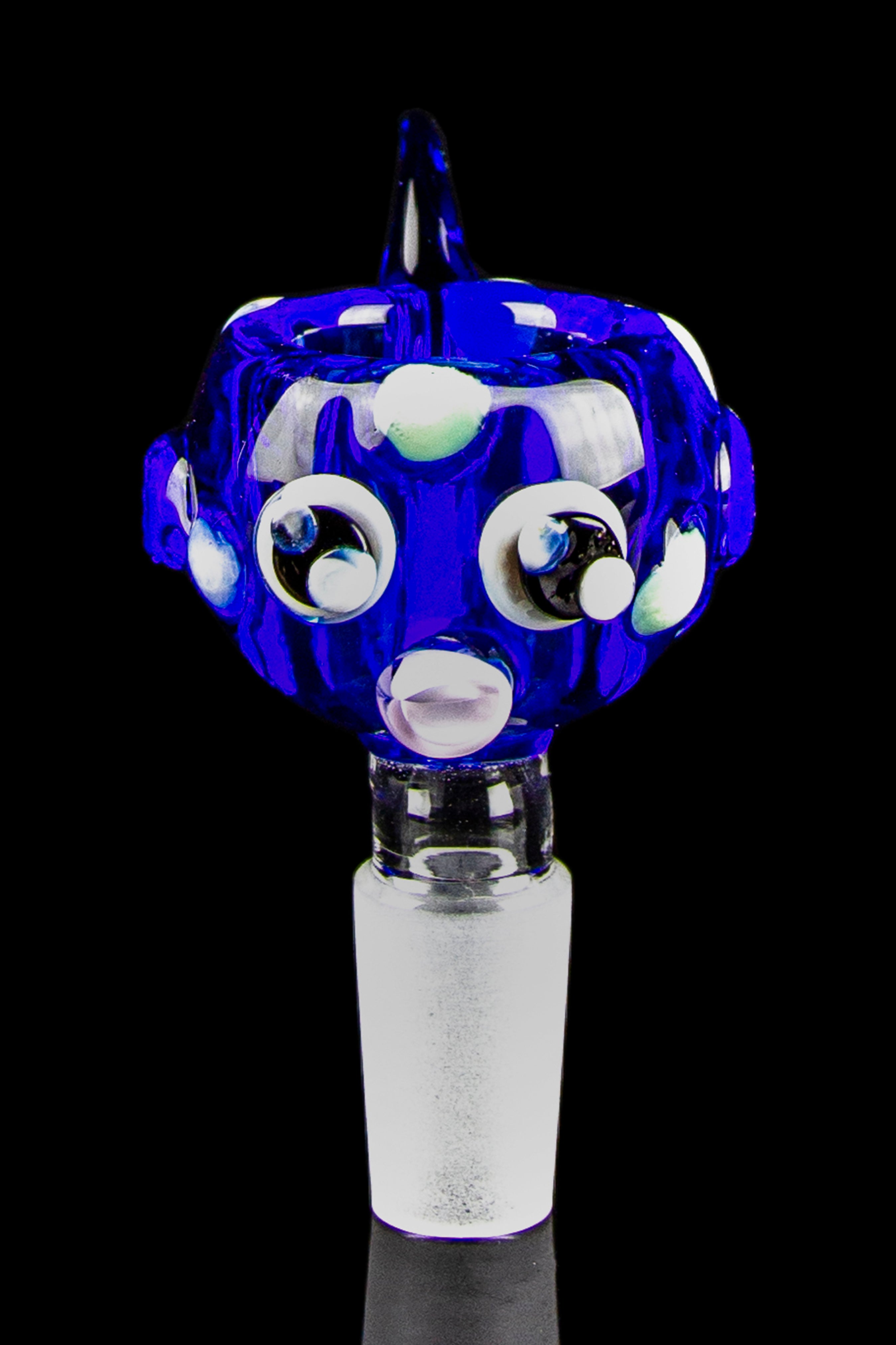 Blue glass cannabis water pipe attachment with white and black eye-like designs.
