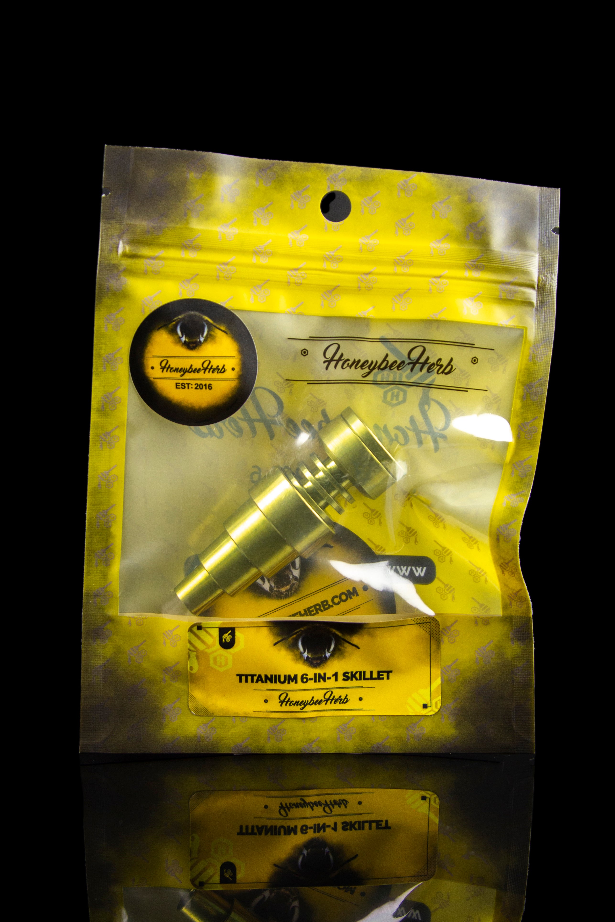 Gold bag of Honeybee Herb titanium 6-in-1 skillet cannabis accessory.