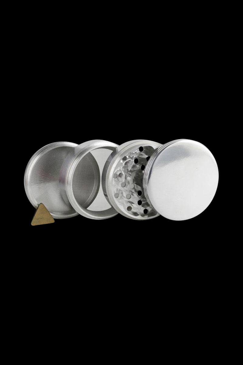 A disassembled view of the Classic 4-Piece Metal Grinder, showing its four silver metal components arranged in a row.
