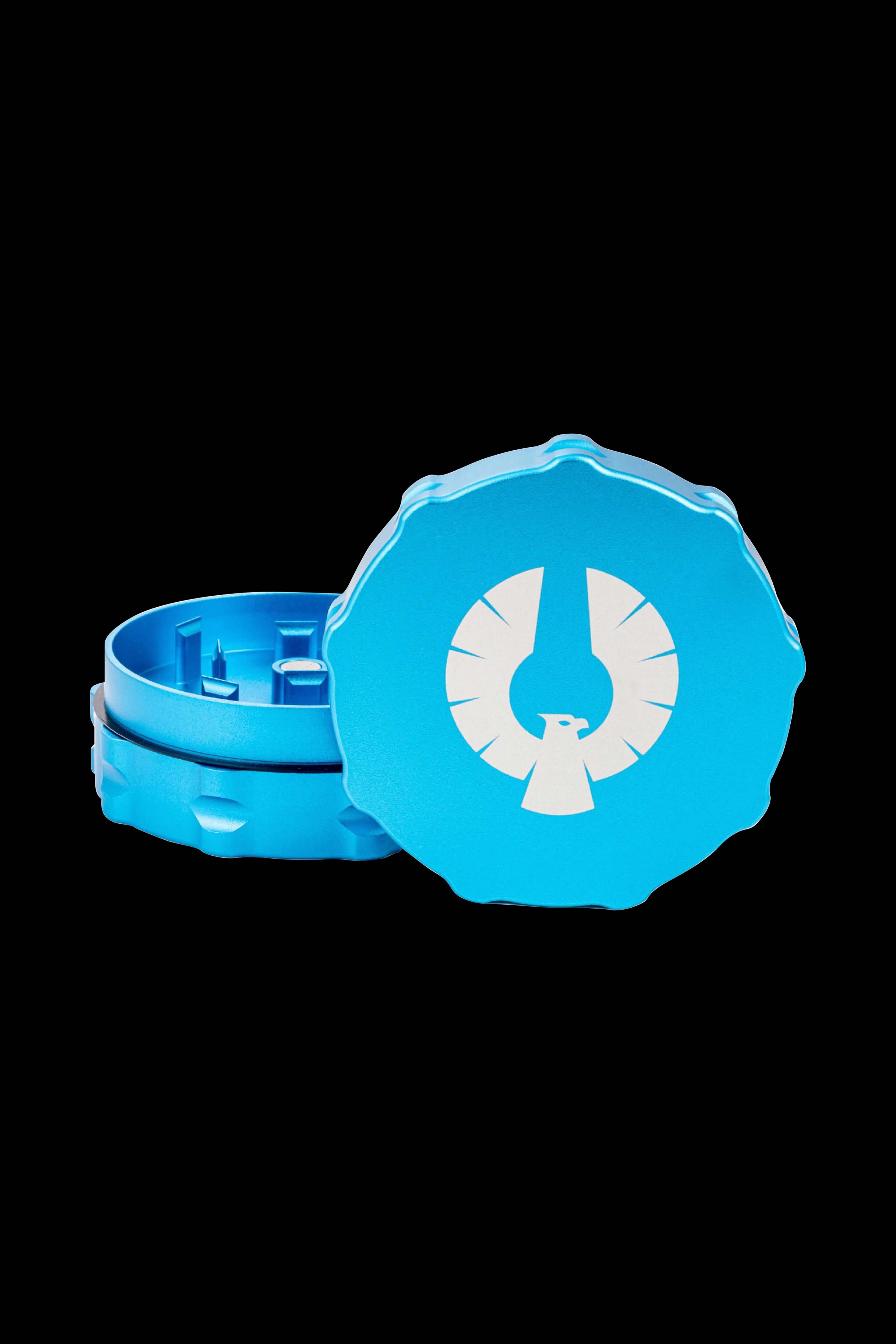 Blue cannabis grinder with a phoenix logo, partially disassembled.