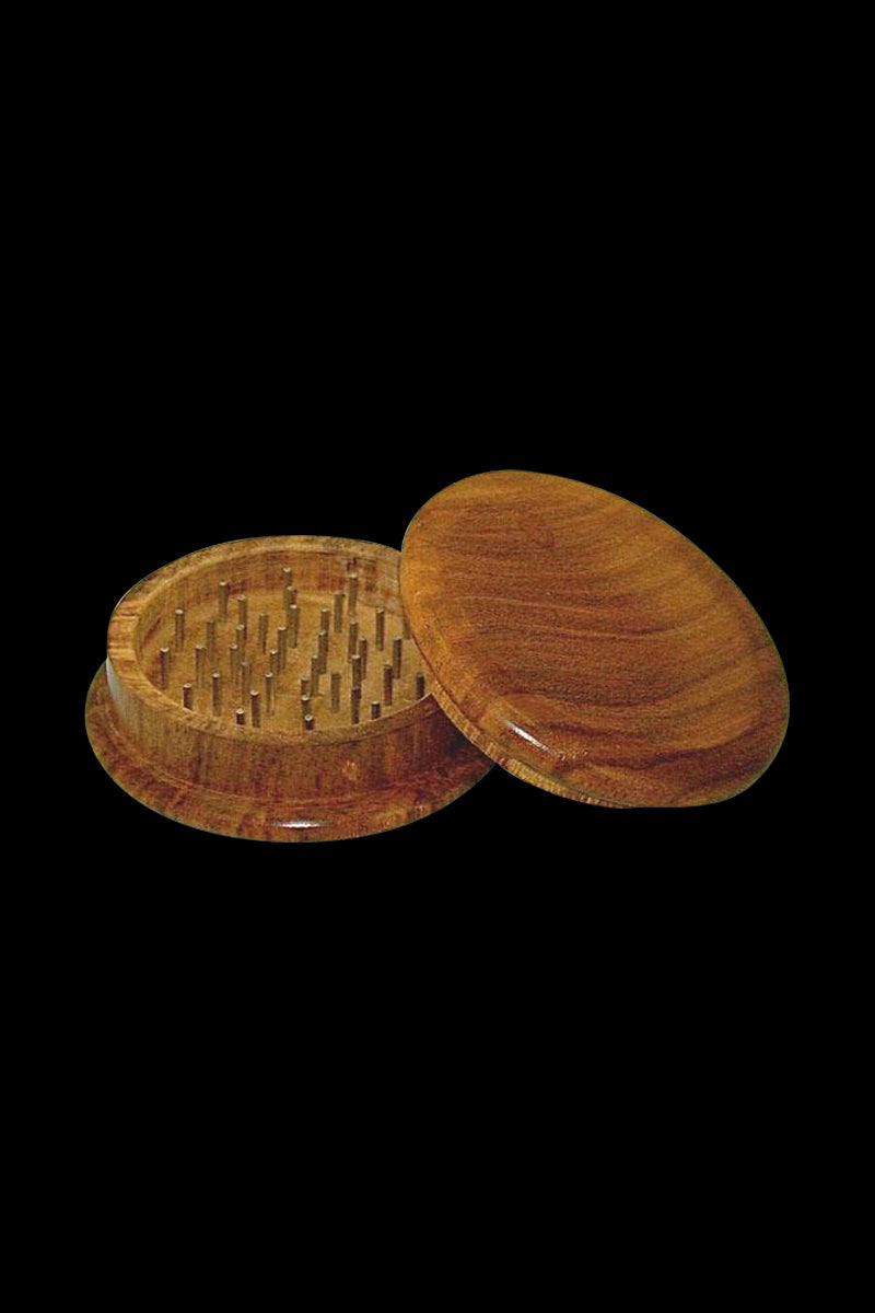 A top-down view of the Round Wood 2-Piece Grinder, showcasing its two circular wooden pieces separated on a neutral background.