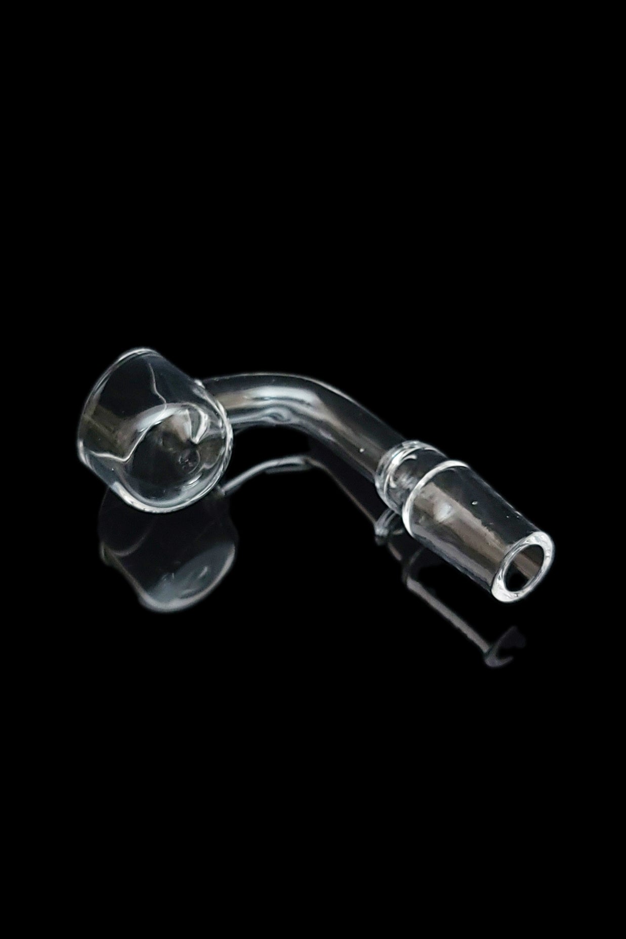 Clear glass dab nail with reflection on black background.