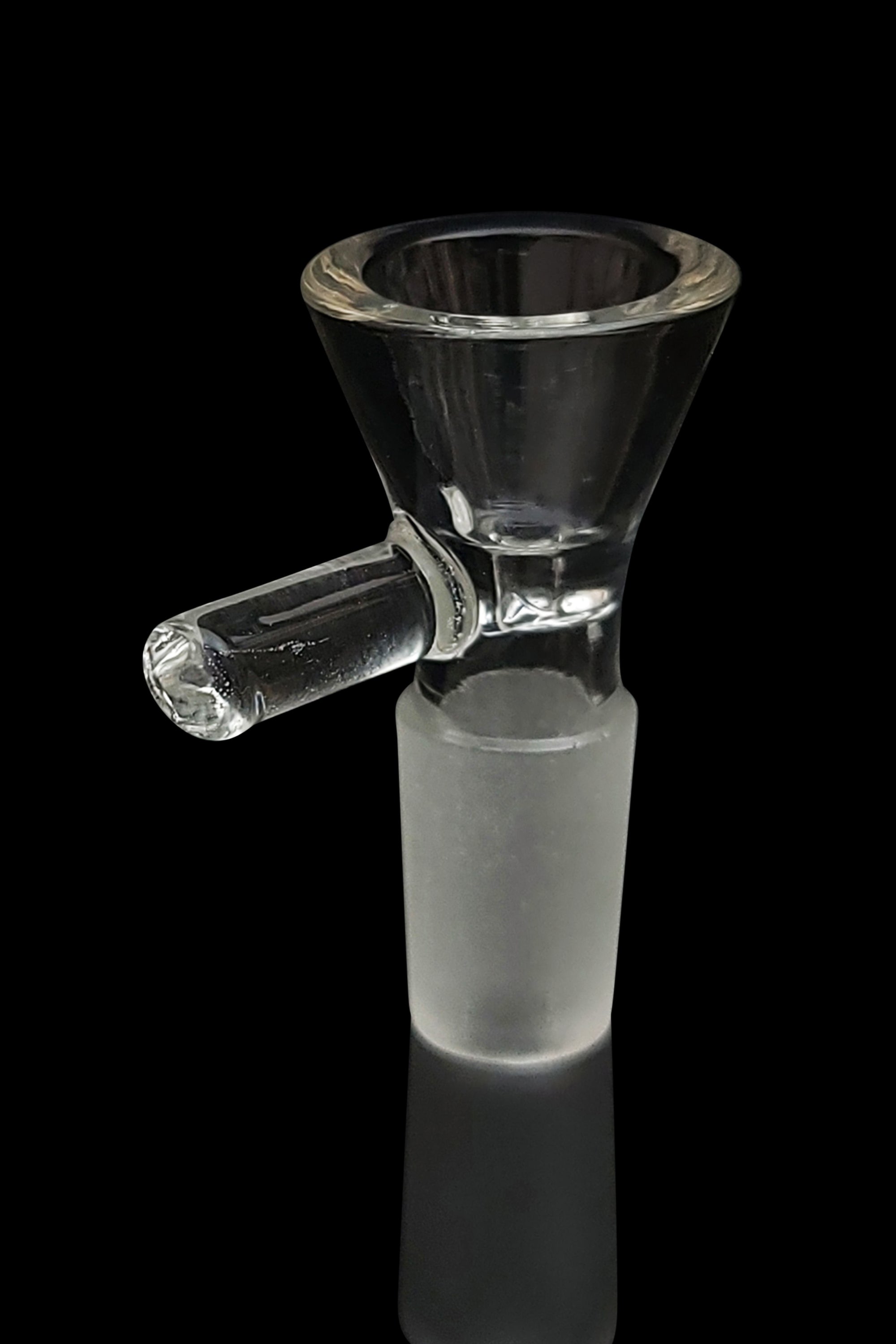 Clear glass bowl piece for a water pipe, reflecting on a dark surface.