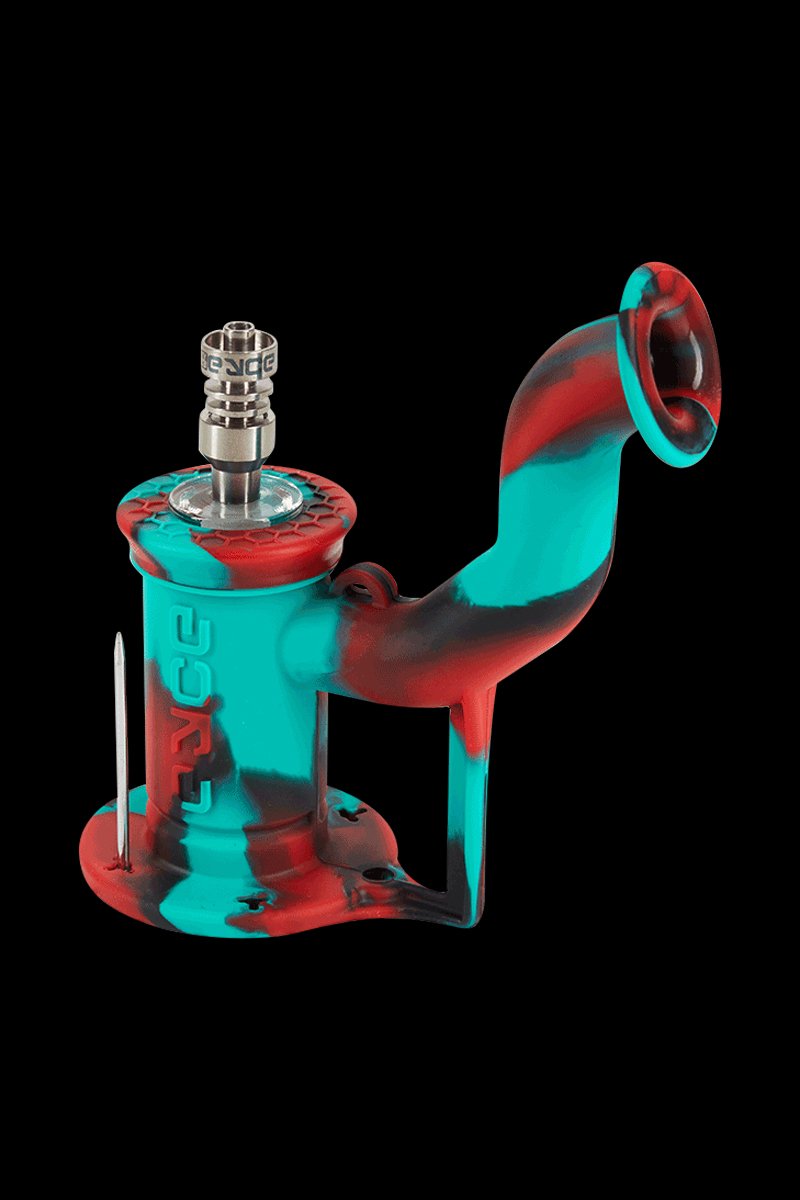 Angled studio shot of the EYCE Rig II Silicone Bong in blue marble showing its curved neck, hex-textured top, metal nail, and marbled red-and-teal body against a black background