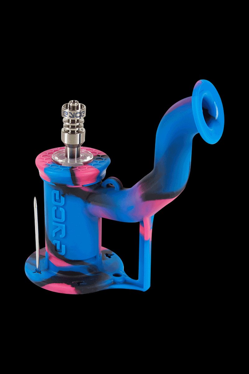 Angled studio shot of the EYCE Rig II Silicone Bong in blue and pink swirled silicone, shown against a black background with a metal nail and raised mouthpiece.