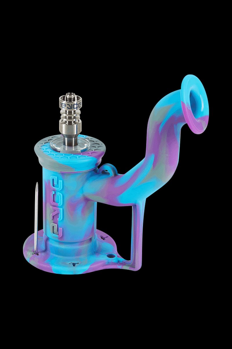 Angled close-up of an EYCE Rig II Silicone Bong in swirled blue and purple, shown against a black background with the metal nail visible.